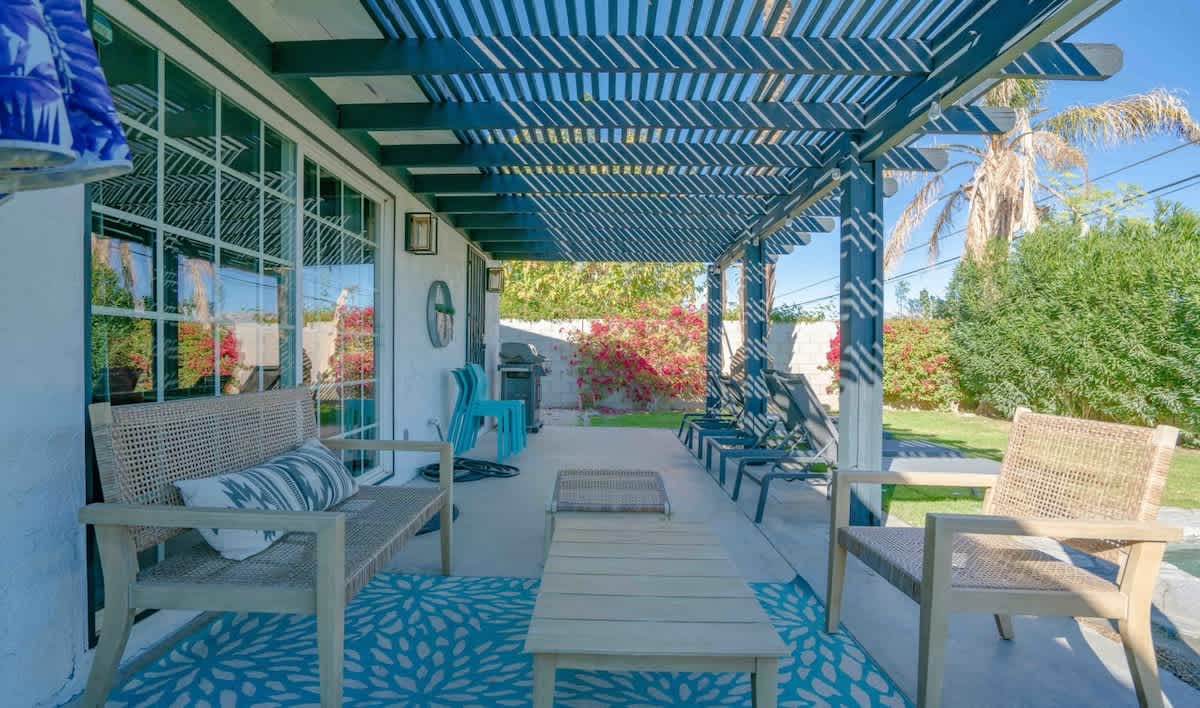 Covered patio with lounge seating, steps from the pool.