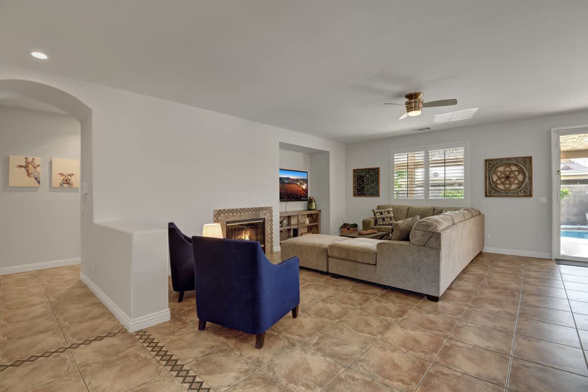 Second living area with cozy fireplace, sectional and TV.