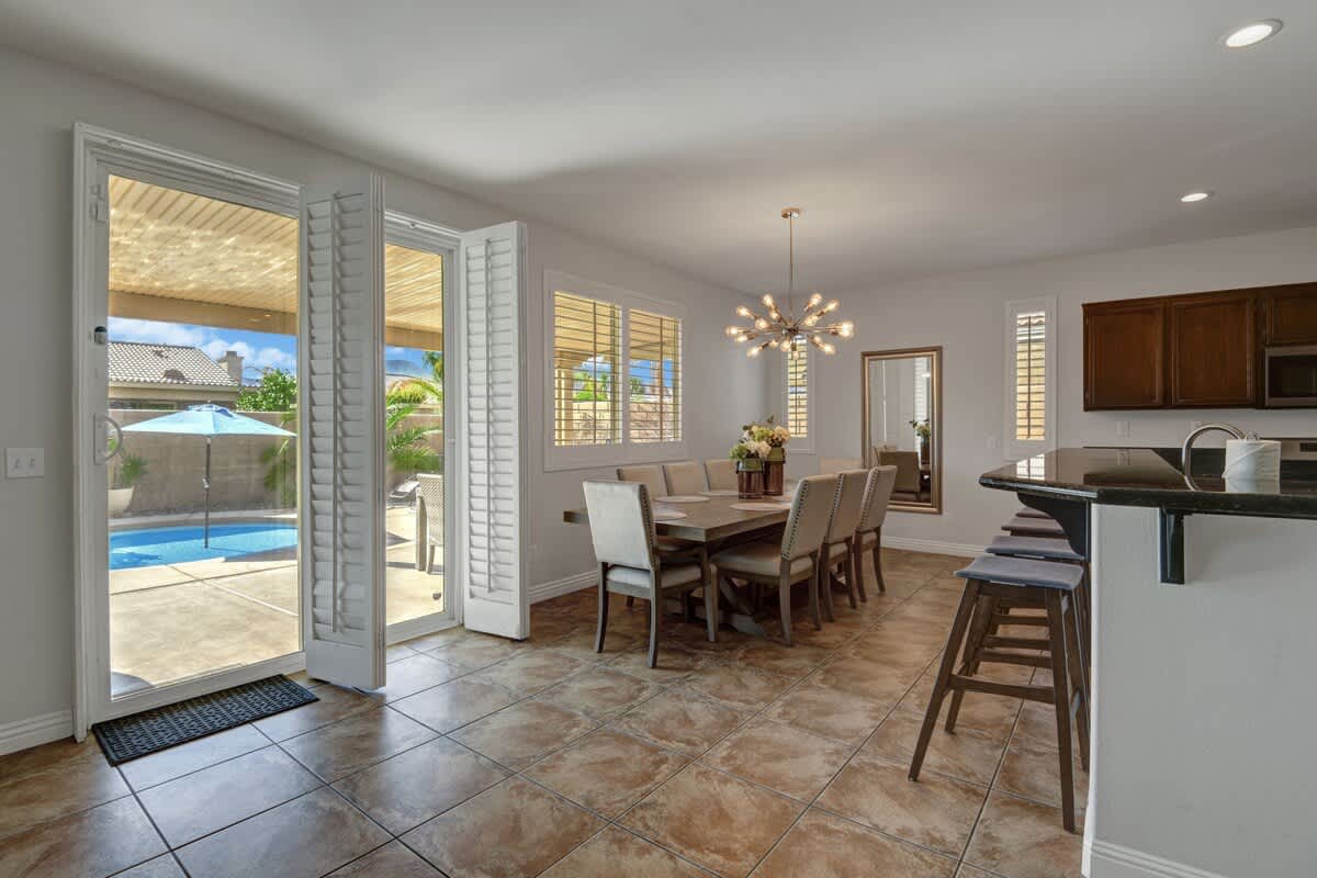 Second dining area with patio doors opening to the pool.