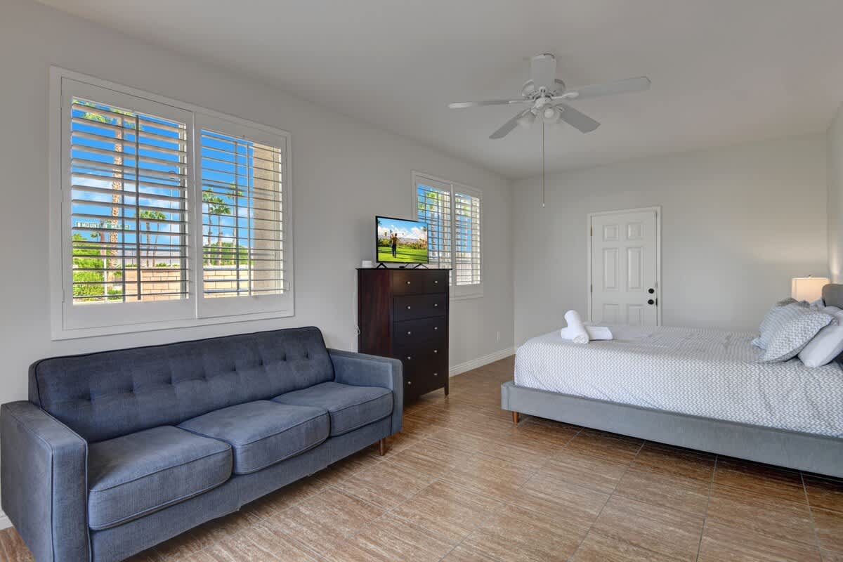 Second bedroom featuring King Bed and comfortable couch sitting area.