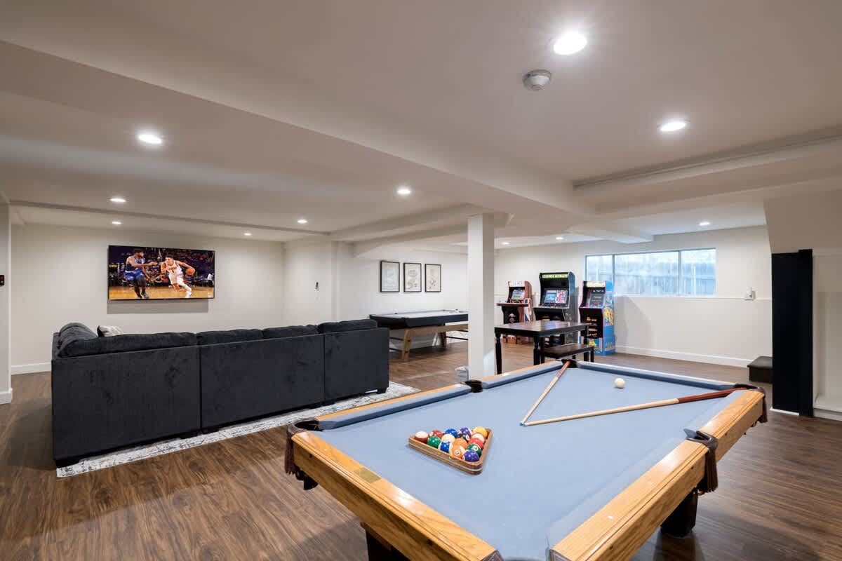Huge downstairs game room with 75 inch TV.