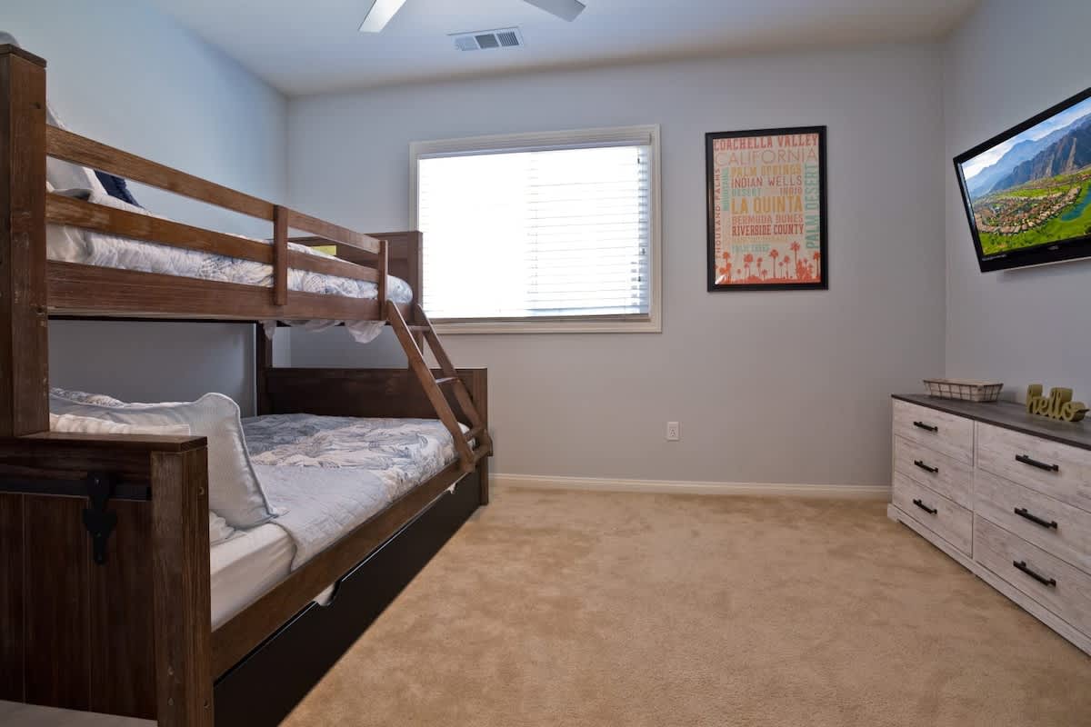 Bunk room with twin-over-full bunk bed and Smart TV.