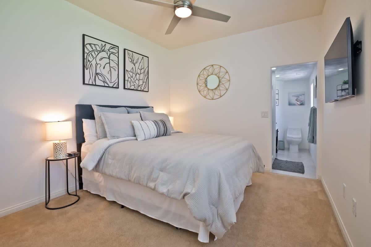 Queen bedroom with private bathroom and Smart TV.