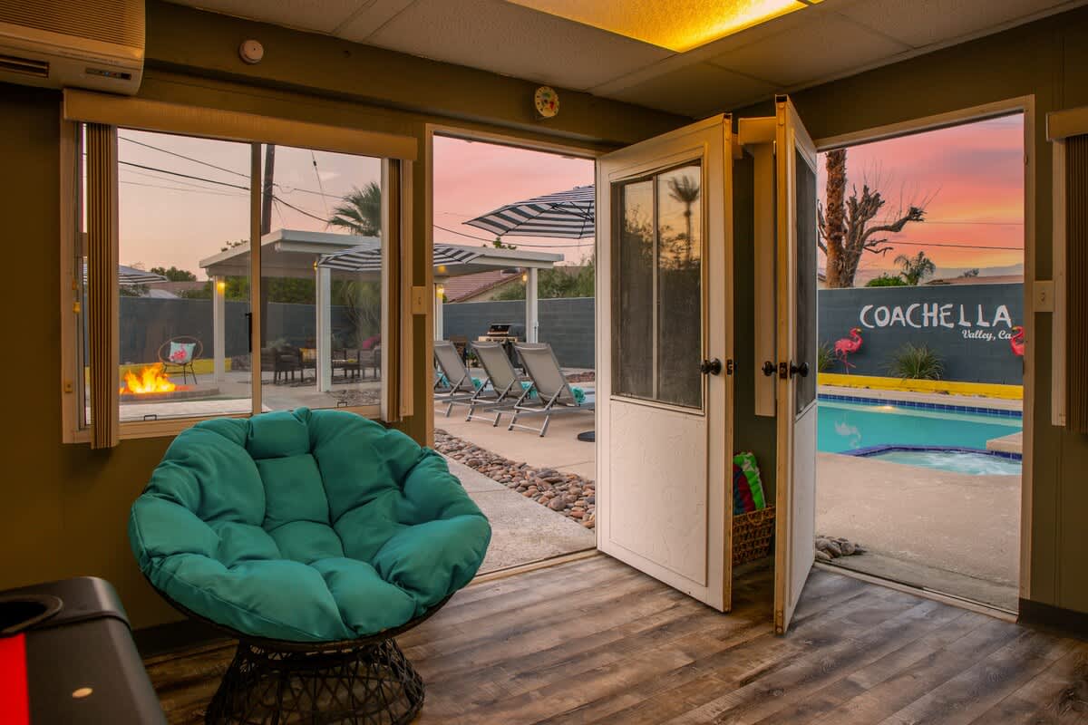 Game Room opens up to amazing backyard pool and grass.