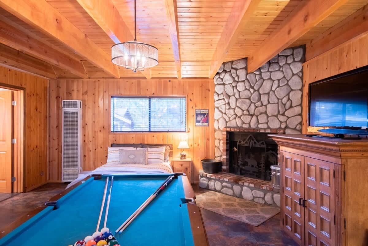 Guest house game room: pool table and fireplace