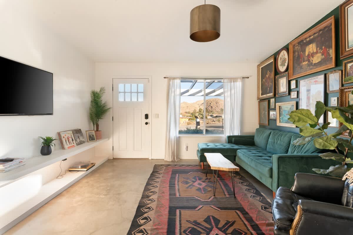 Living room with velvet sofa and streaming Smart TV.
