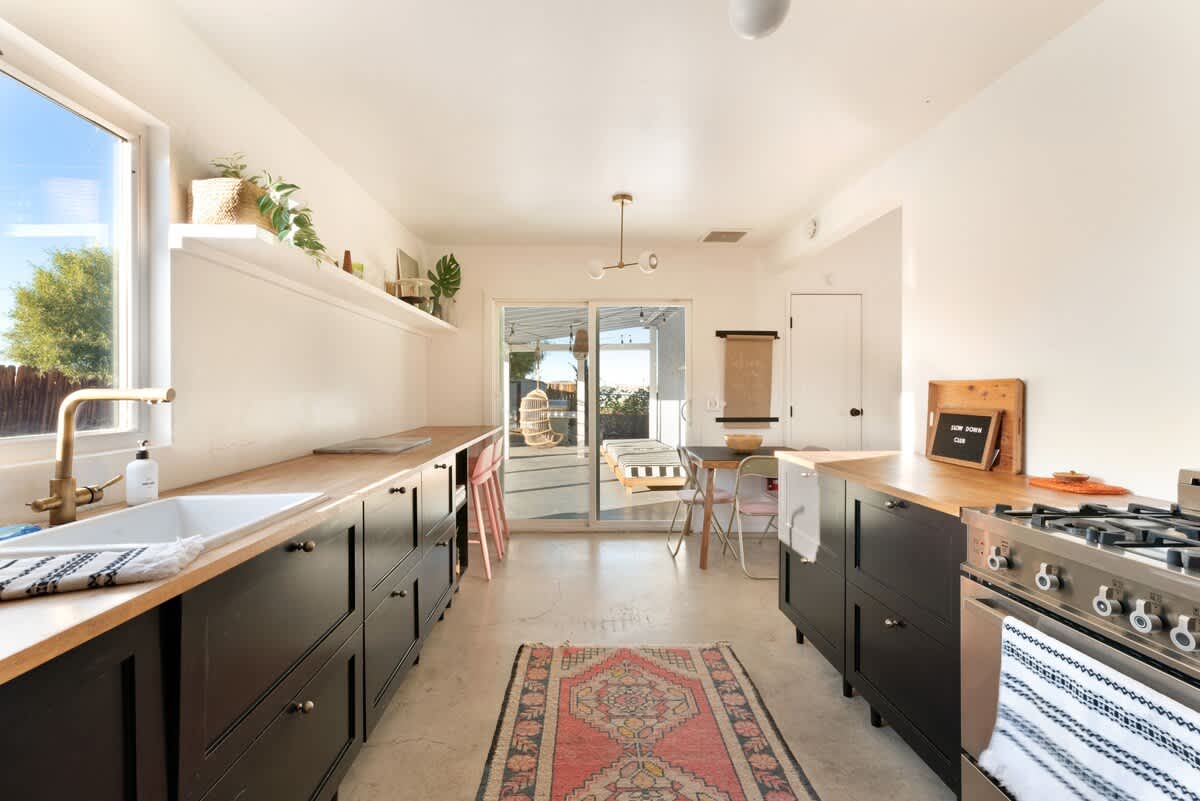 Fully equipped kitchen opening to the backyard.