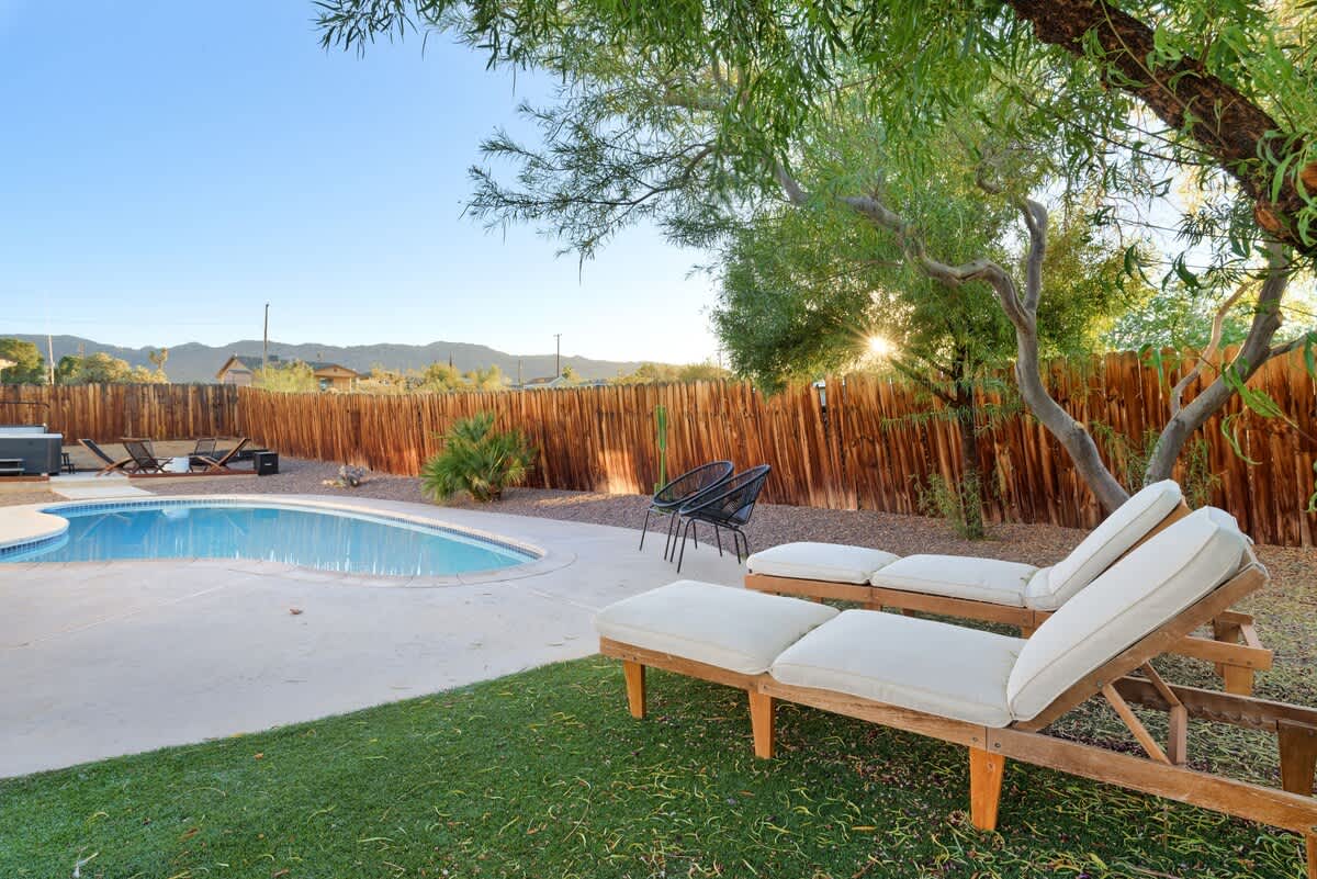Lounge chairs by the private pool with mountain views.