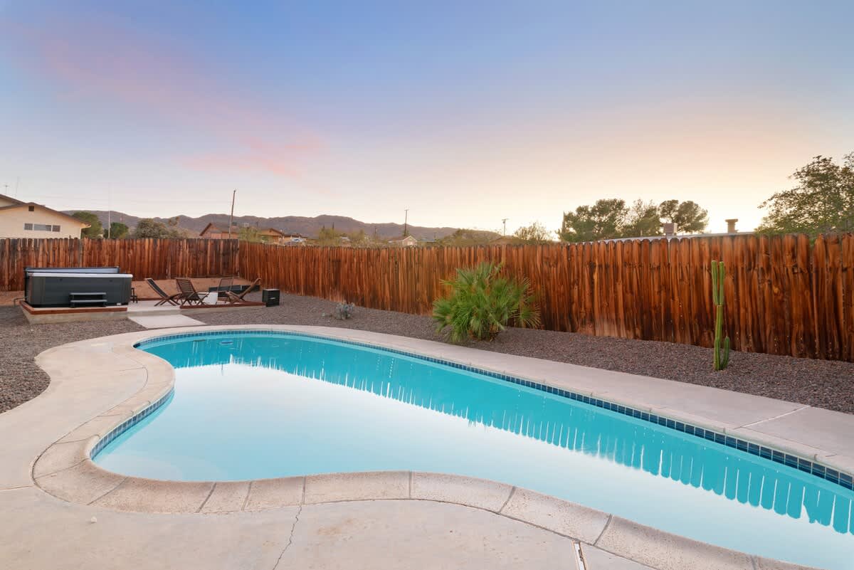 Private pool with mountain views at sunset.