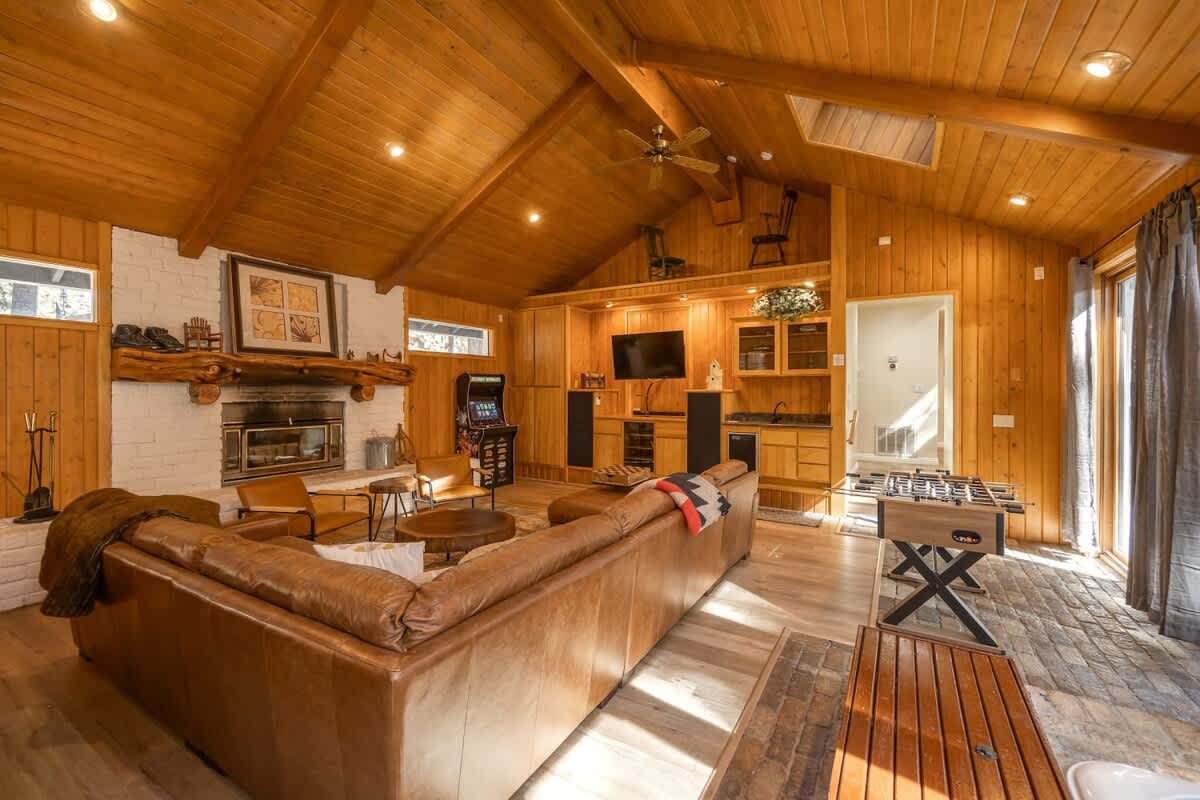 Family room with wood-burning fireplace and foosball