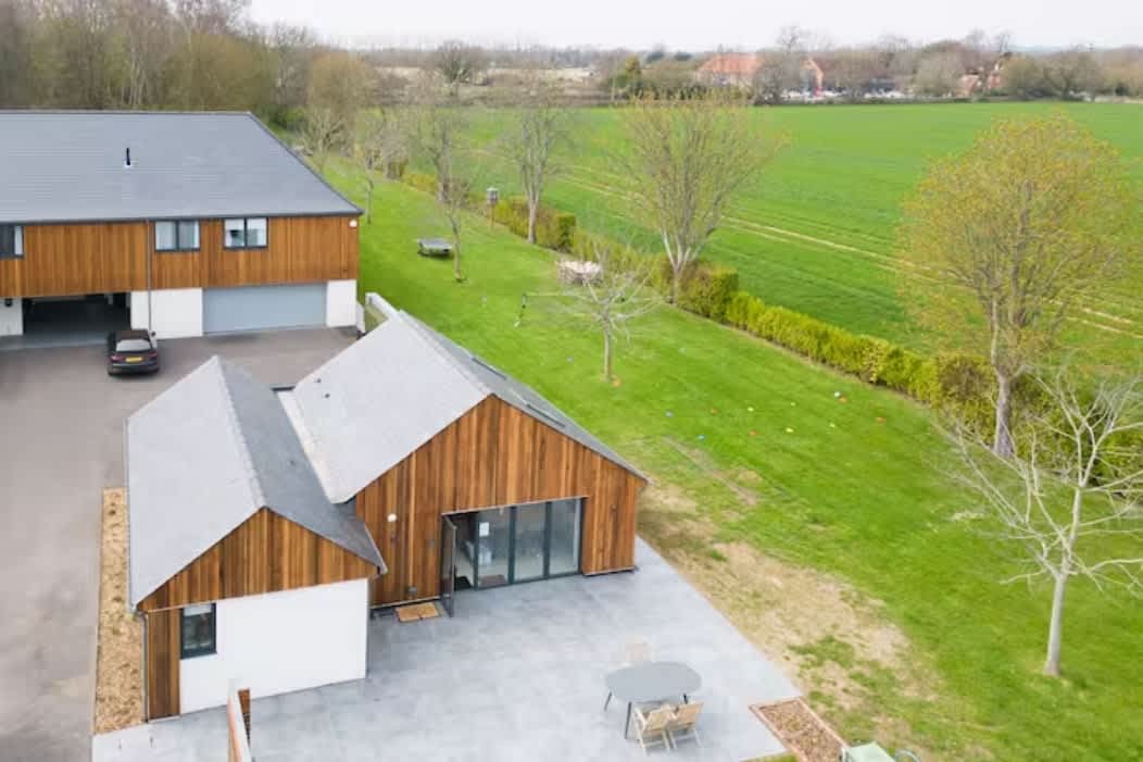 Modern countryside retreat featuring a spacious main house and charming annex, perfect for families or groups. Enjoy expansive outdoor space with stunning field views, ample parking, and a private patio area