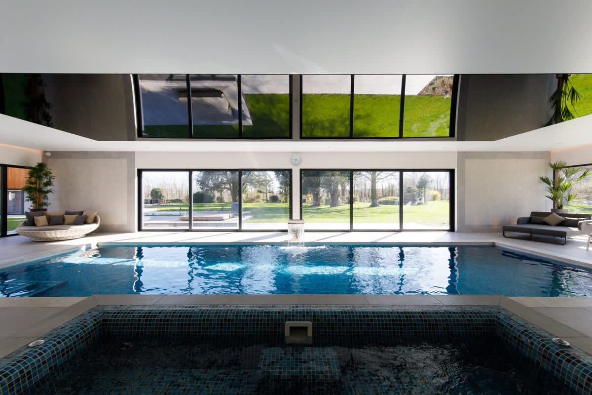 Enjoy the luxurious indoor pool and hot tub at The Cedars, with stunning views of the landscaped garden through floor-to-ceiling windows. A perfect space to unwind. Please note: extra charges apply for pool and hot tub usage.