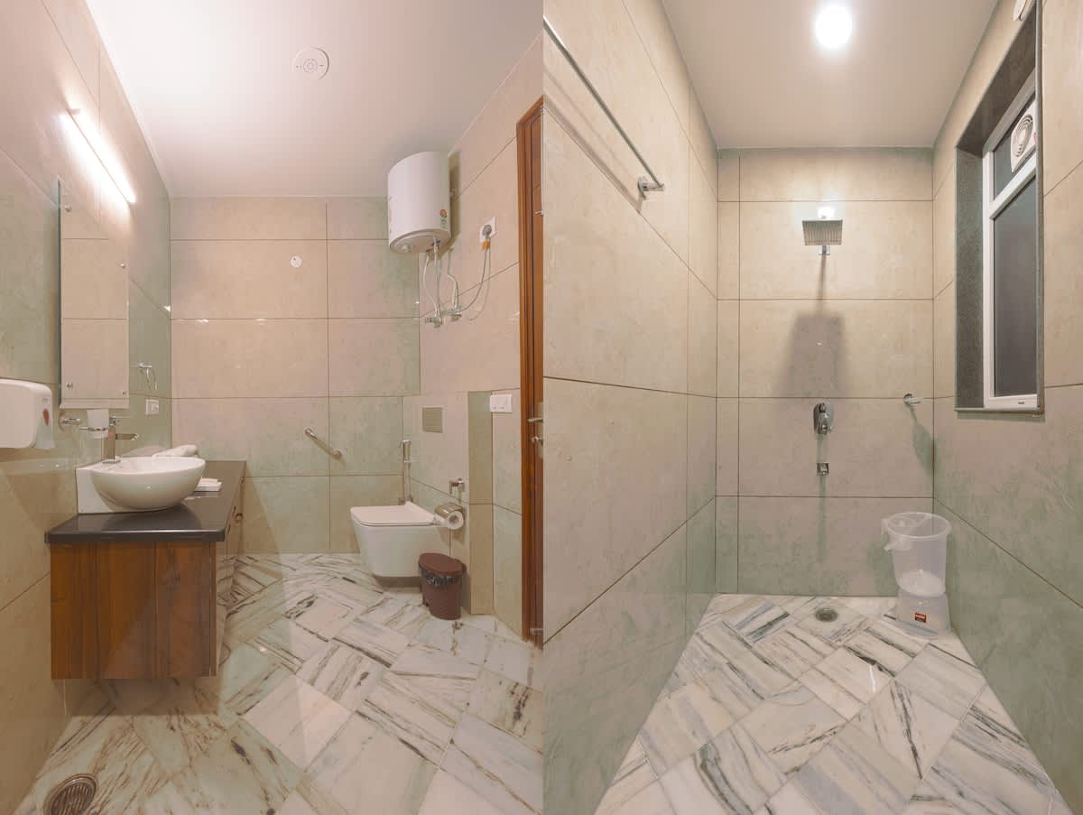 A private attached bathroom featuring modern fixtures, a shower, sink, and toilet for convenience and comfort.