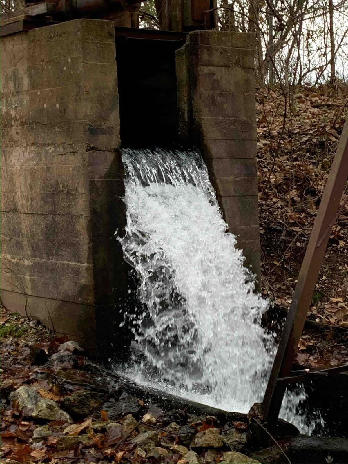 Logan Cave waterfalls and remnants of historic infrastructure that filled gravity fed ponds