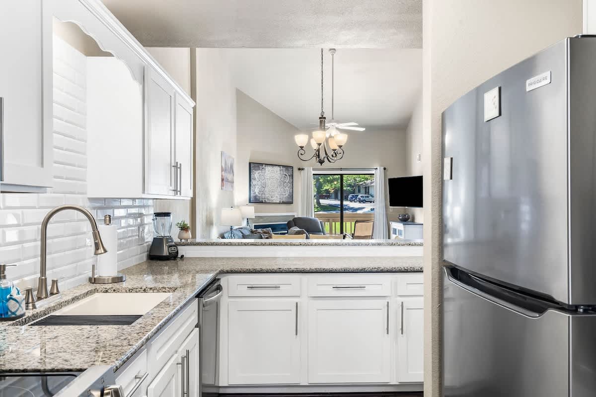 Kitchen with new stainless steel appliances and granite countertops.