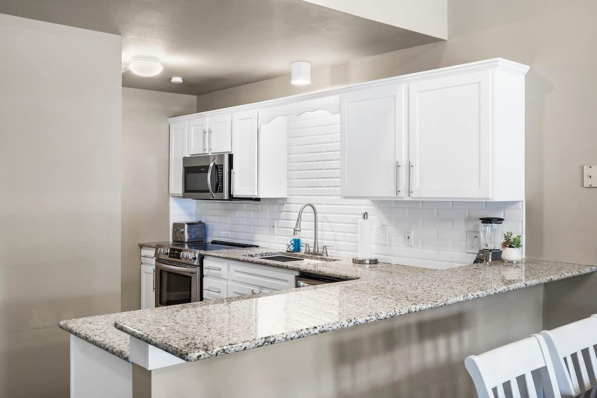 Kitchen with fully stocked cooking utensils and coffee bar.