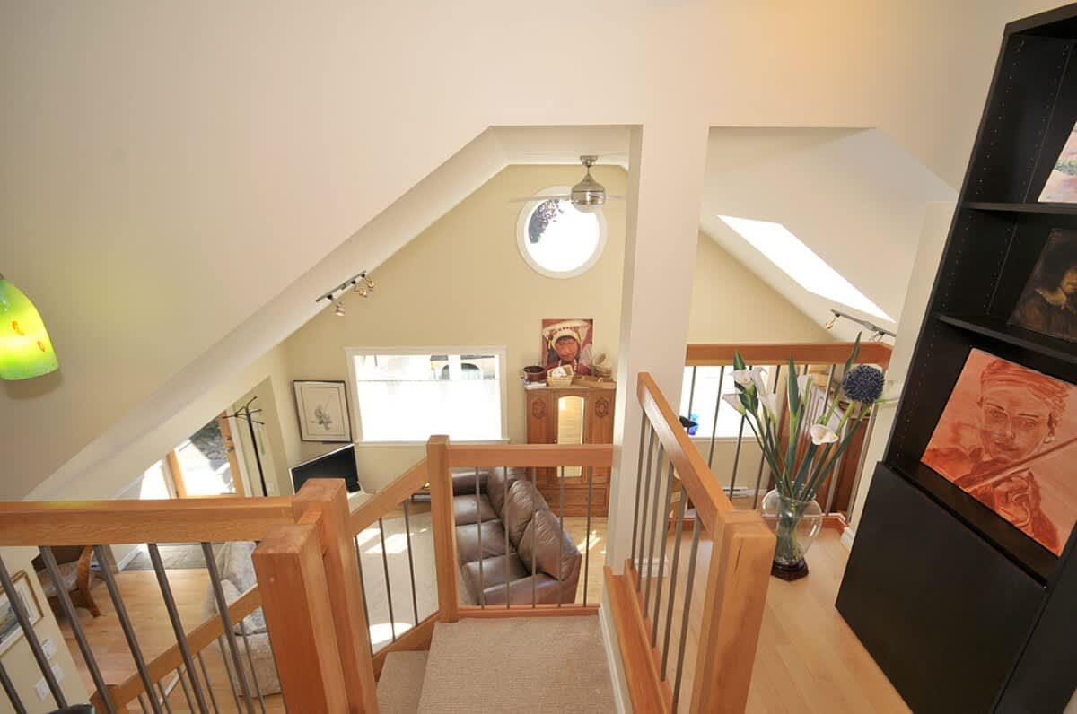 The lofted ceiling of the cottage, lovely wood work accents, and large windows create a bright and open ambiance which is carried throughout the residence.