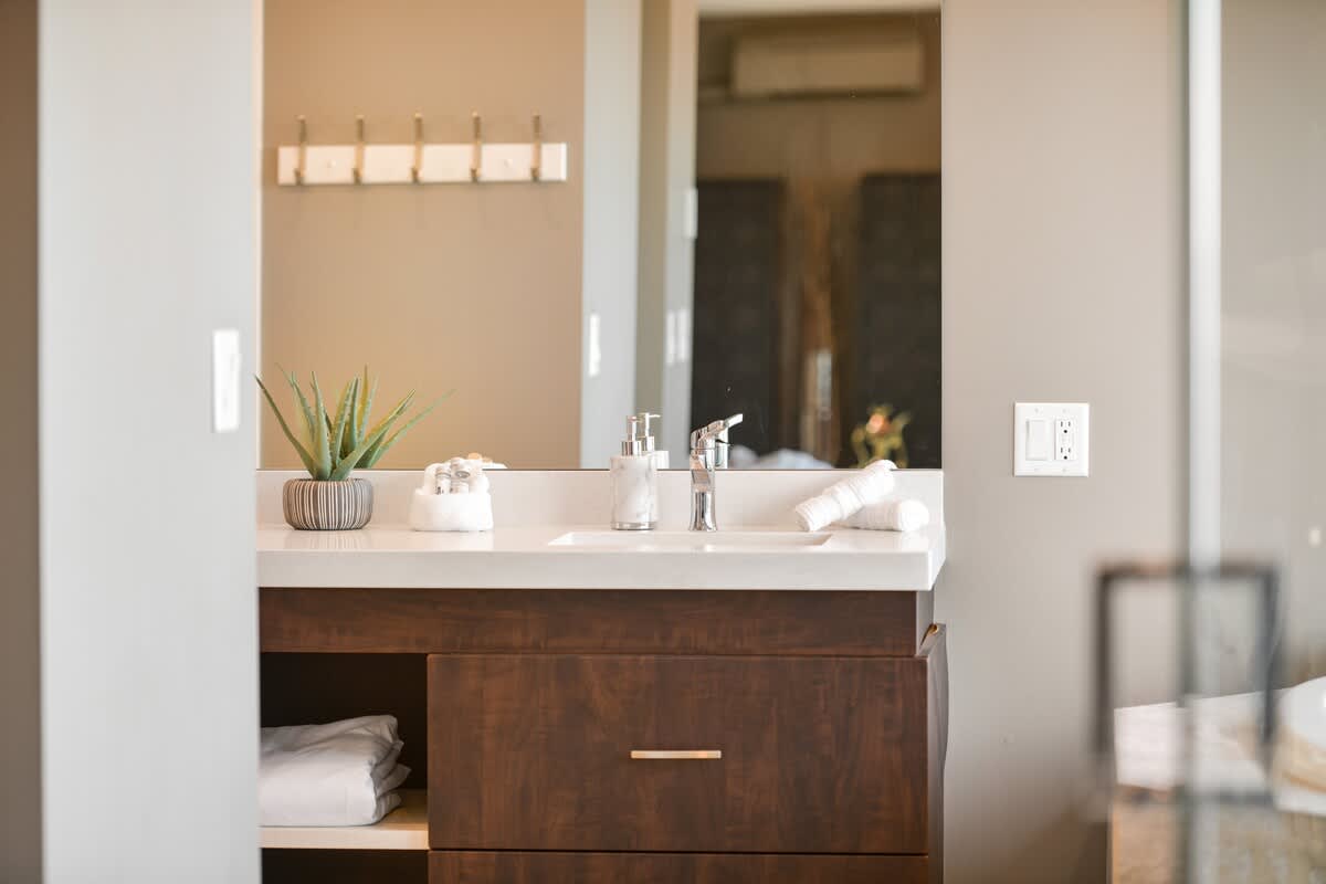 Primary bedroom suite on the top floor with king bed, private deck, living room and full ensuite with walk in closet.