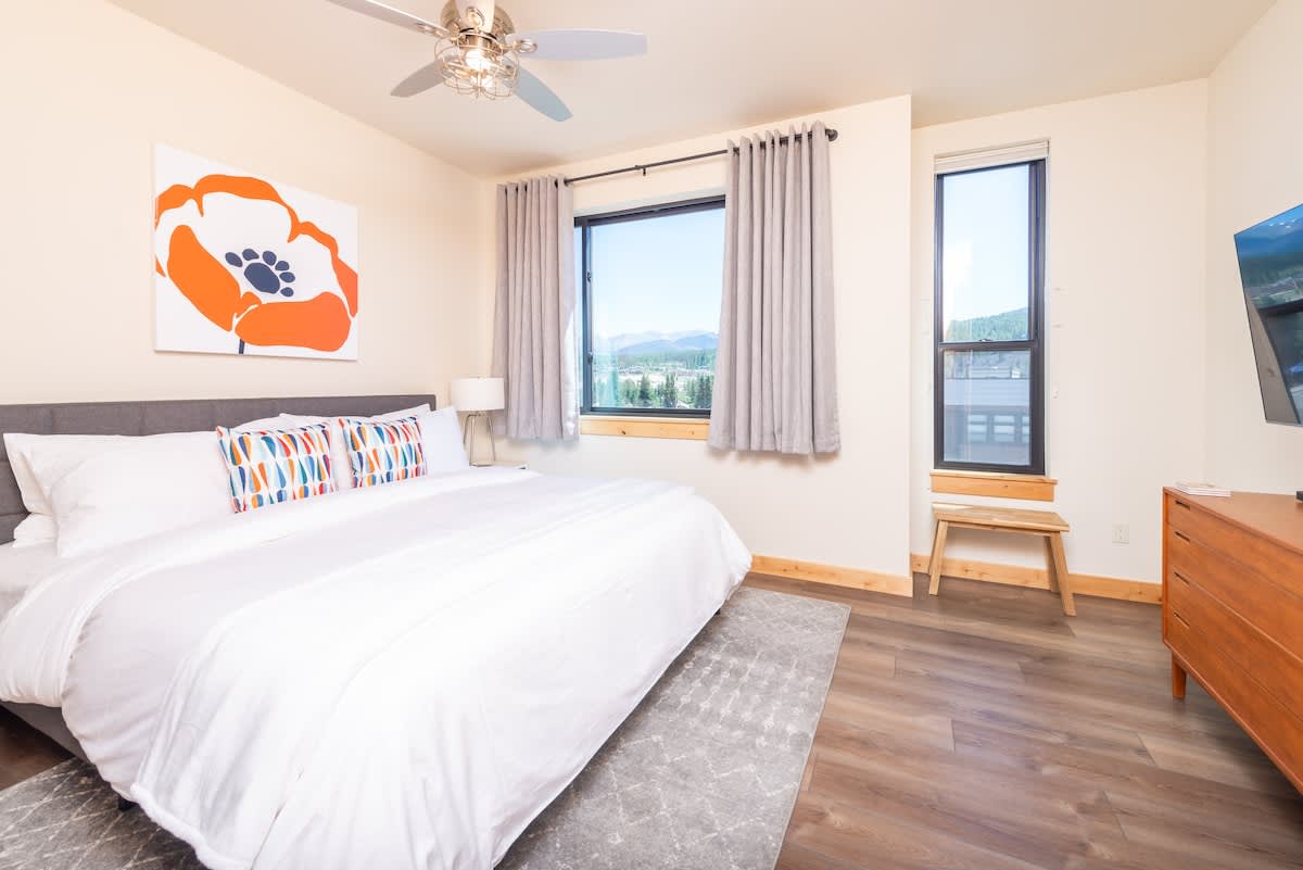 - Enjoy mountain views from bed or unwind with your favorite shows on the smart TV across the room
- Neutral tones and a poppy print keep the space calm and cheerful
- From sunrise to movie night, this bedroom has everything you need