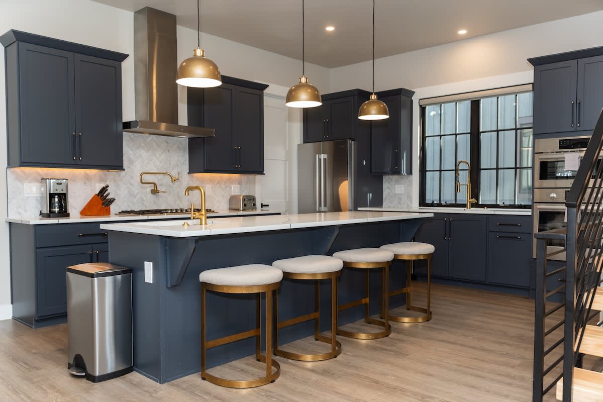 - Contemporary kitchen with large island and seating for four
- Stainless steel appliances and plenty of cabinetry for storage
- Open layout ideal for cooking while socializing with guests