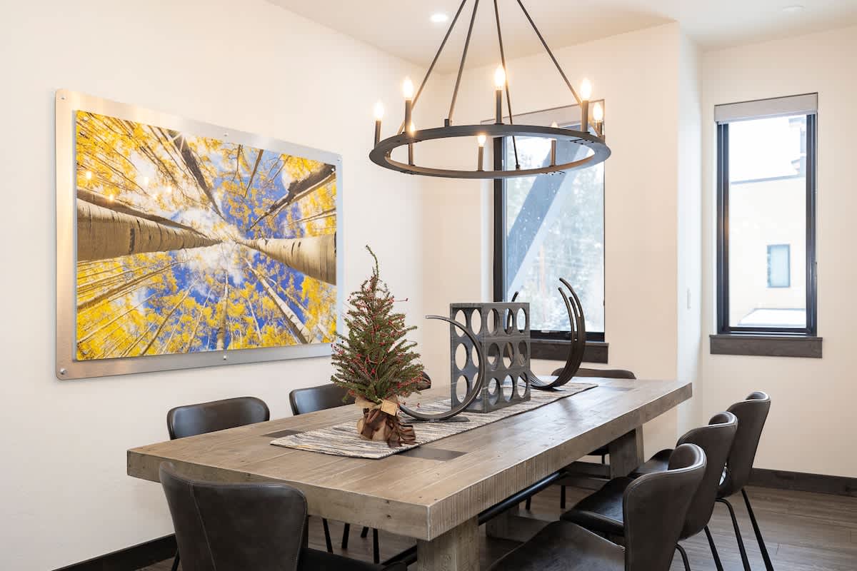 - Share stories and meals under a striking chandelier and radiant forest inspired art
- Rustic wood table offers the perfect place for game nights or gourmet spreads
- Big window views and warm design bring every seat to life