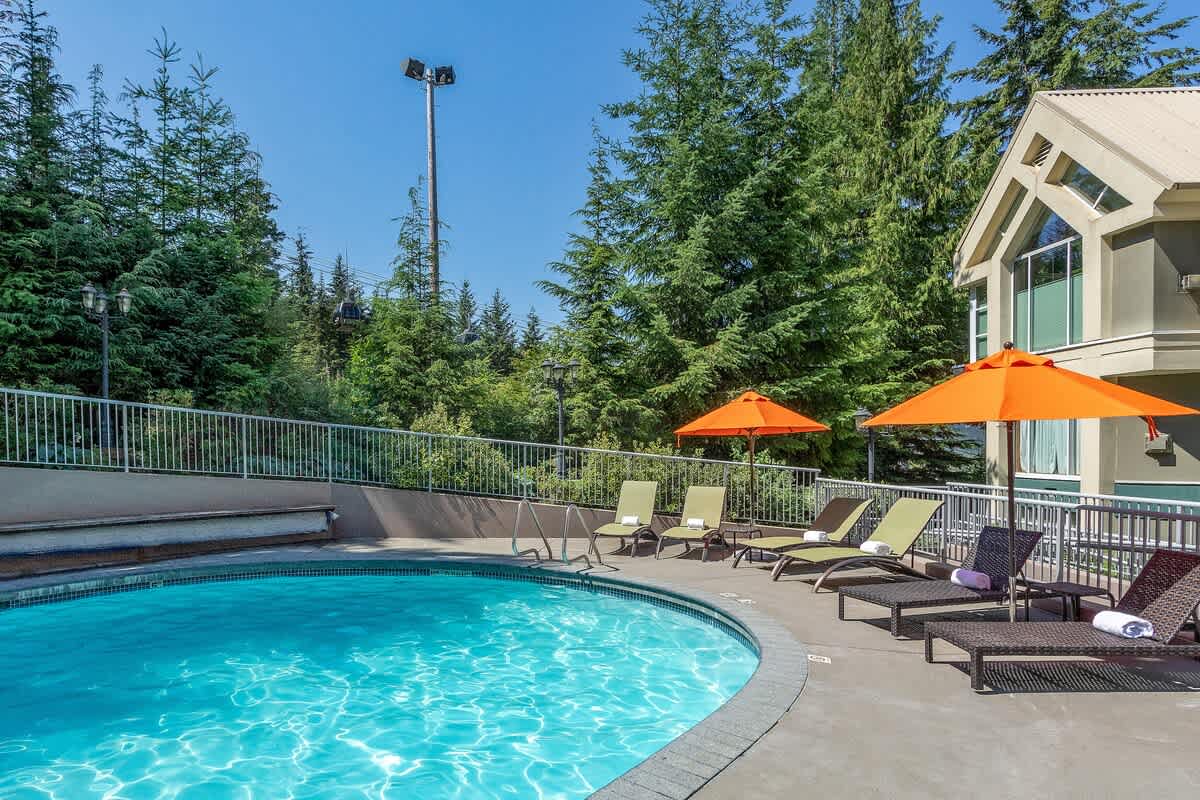 - Sparkling heated outdoor pool surrounded by forest and mountain views - Lounge chairs and umbrellas invite peaceful relaxation in any season - Ideal for refreshing swims after skiing or exploring Whistler’s trails
