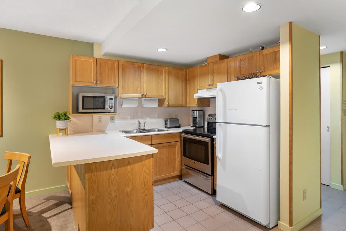 - Fully equipped kitchen with stainless appliances and warm wooden cabinets 
- Cook family meals in comfort after skiing or mountain biking 
- Whistler condo offering convenience and home-like luxury 
