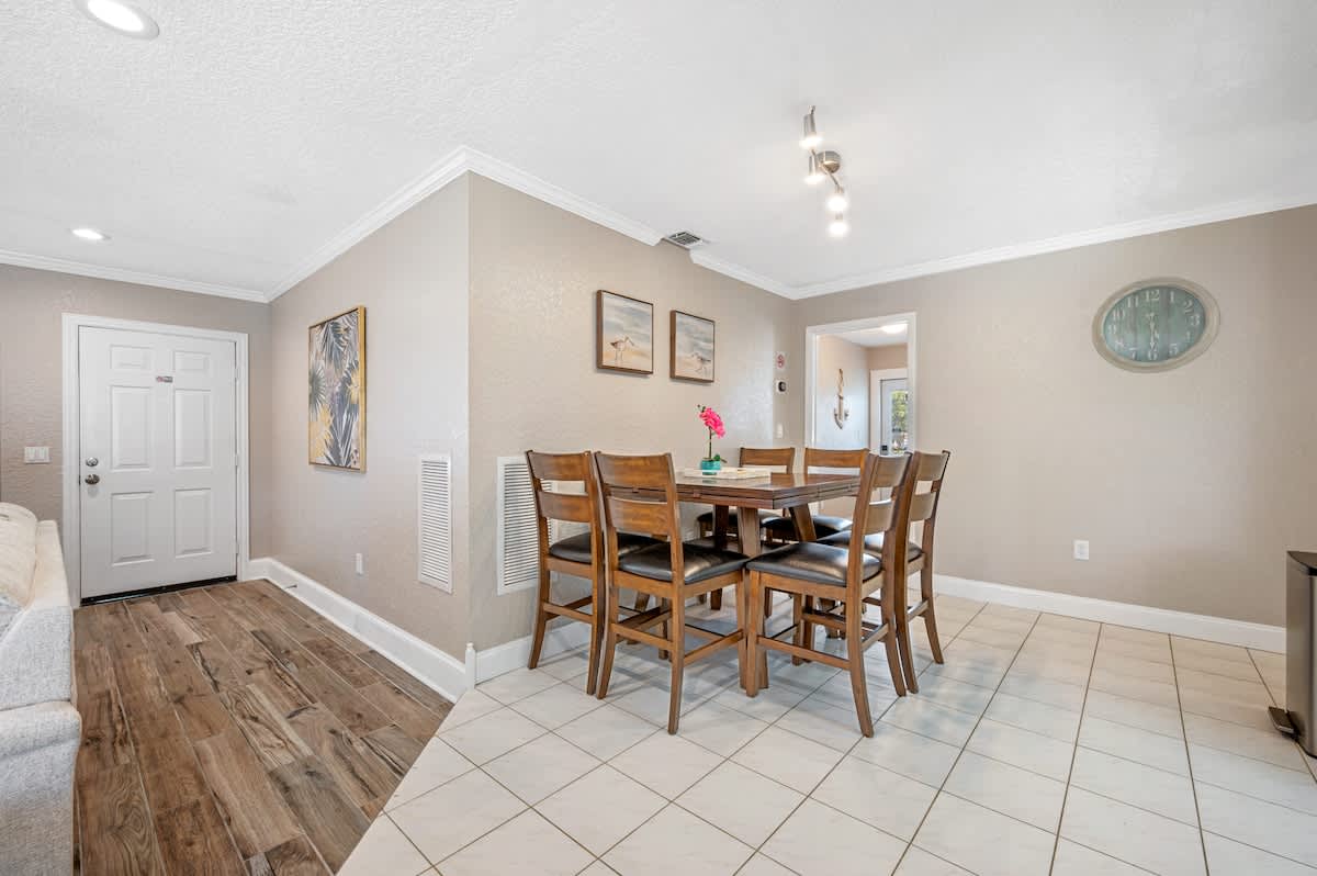 One step from the tile area into the living room area.