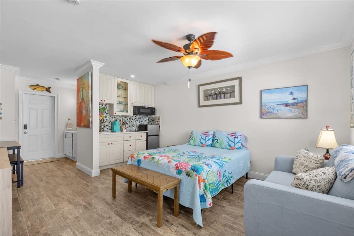 This is a studio apartment where the bed, living area, dining space, and kitchen are all contained within a single room.