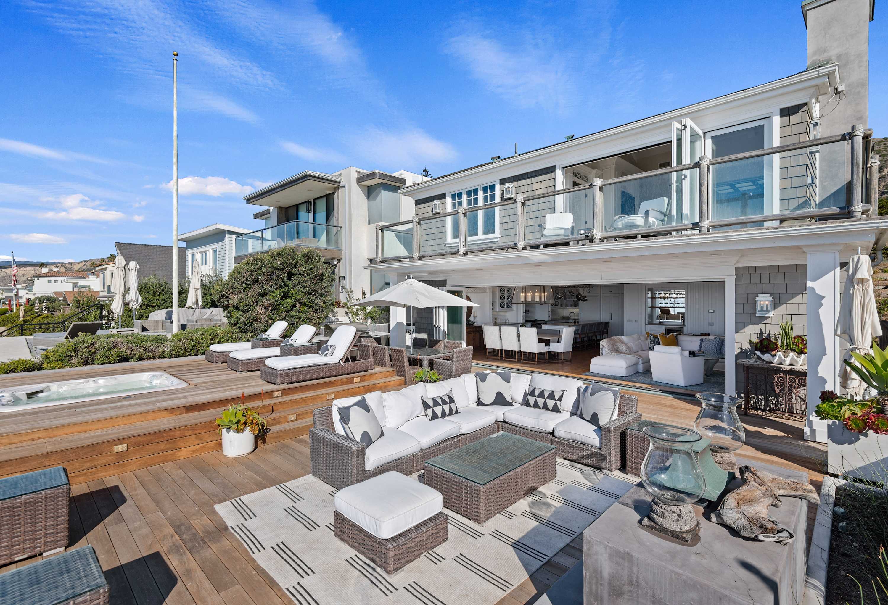 Take advantage of the spacious beachfront deck with hot tub 