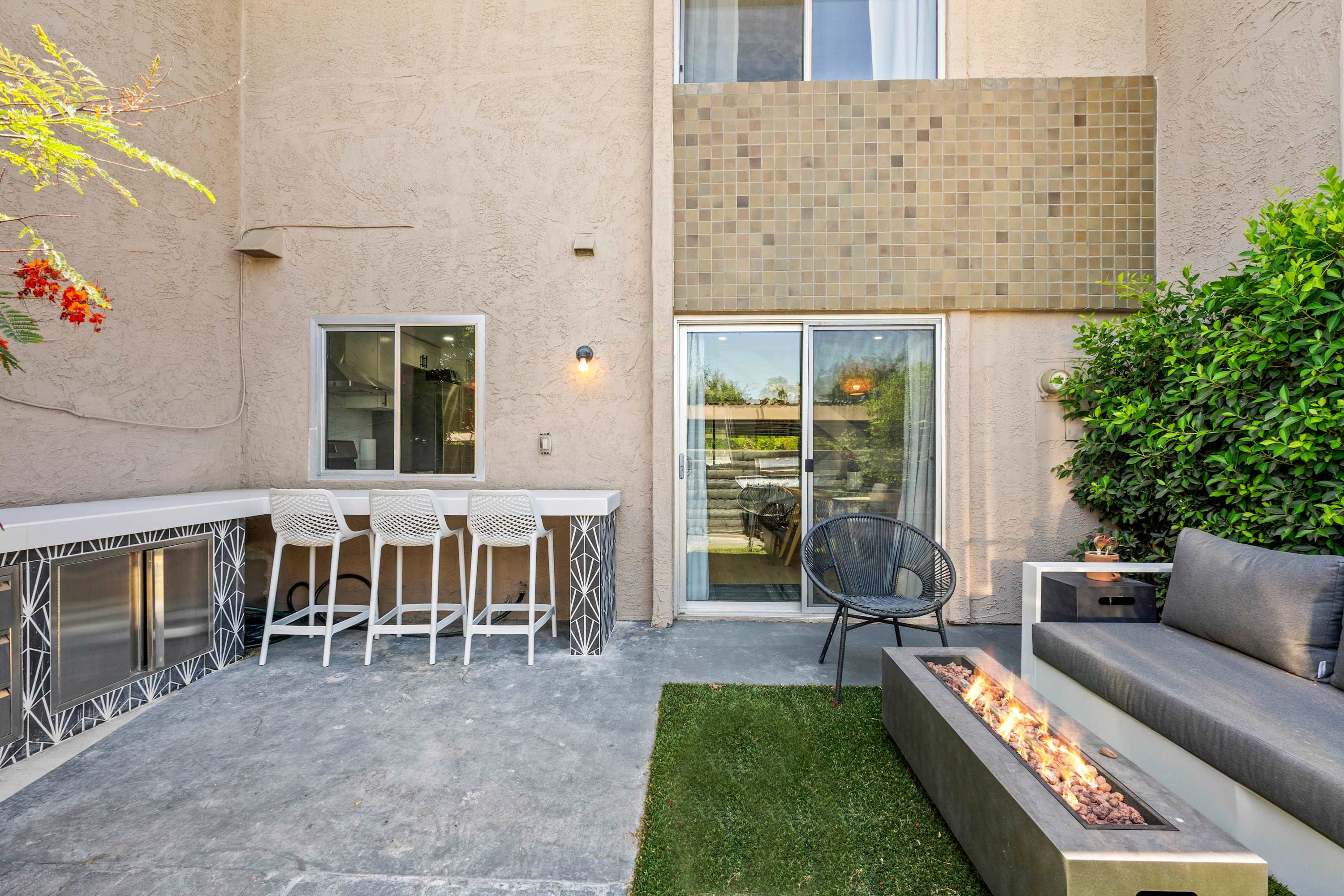 Enjoy evenings in style with this sleek outdoor bar and cozy fire pit