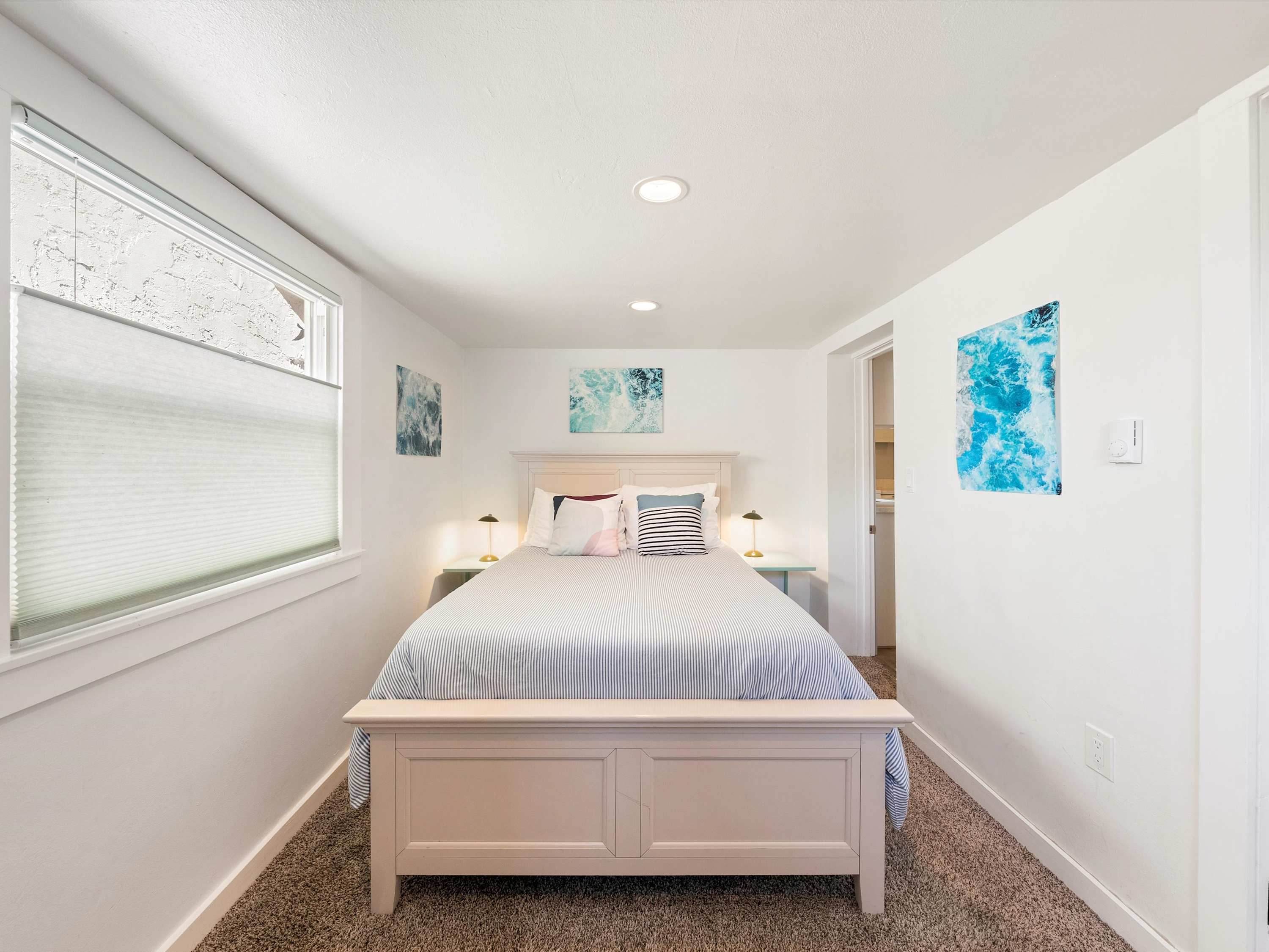 Cozy bedroom featuring a full-size bed with soft linens and a window