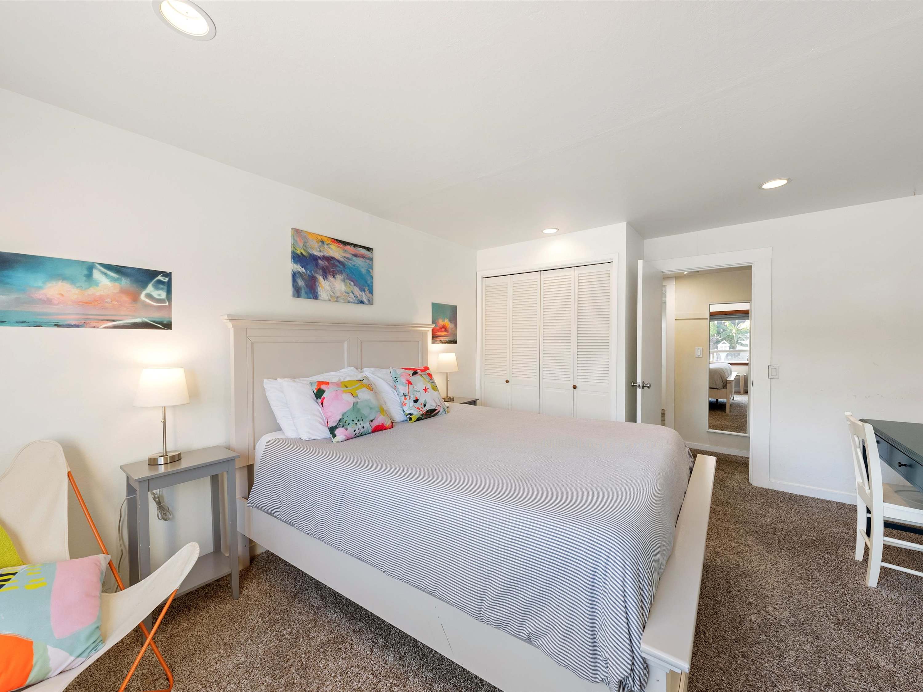 Spacious bedroom featuring a cozy queen-size bed and desk