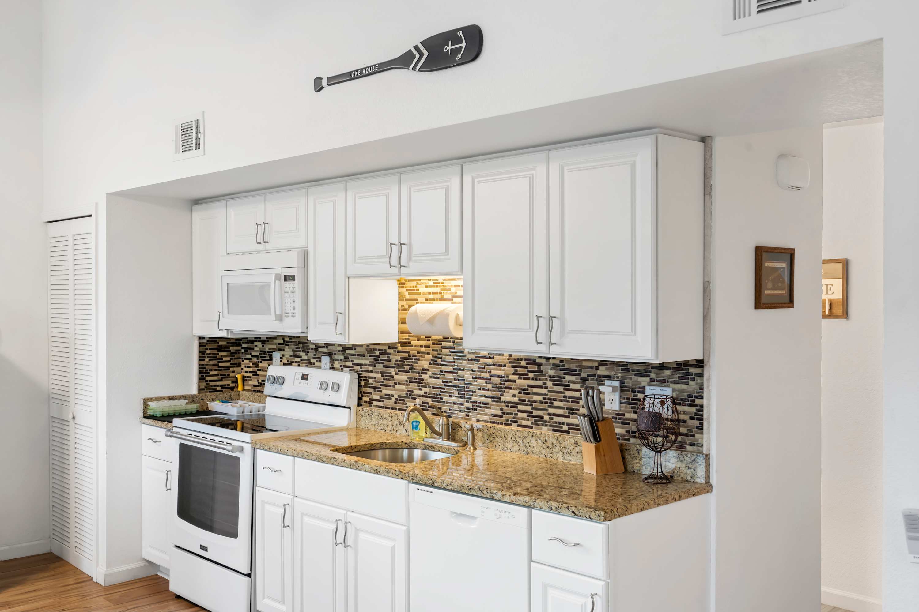 The sleek, efficient kitchen offers ample space & all the comforts of home
