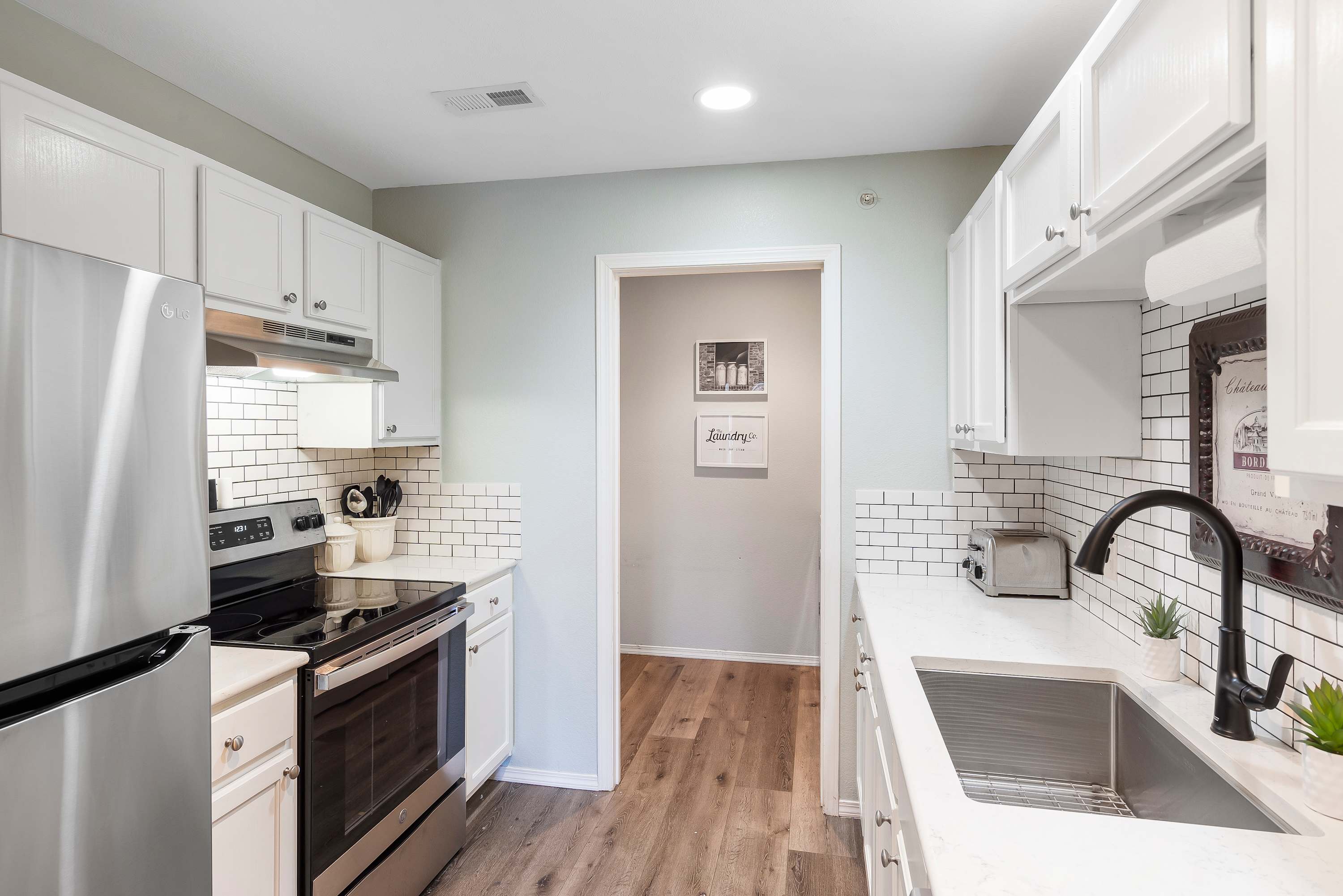 The airy kitchen offers ample space & all the comforts of home