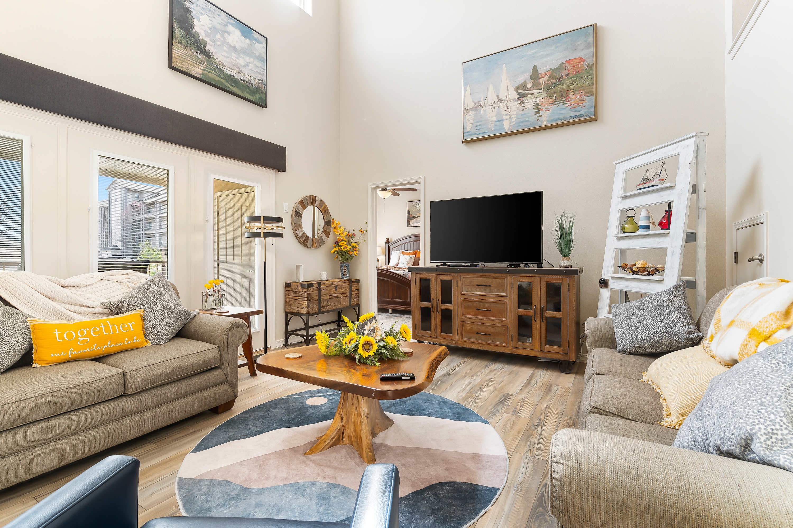 Spacious living room with balcony access TV, and Queen size sofa sleeper