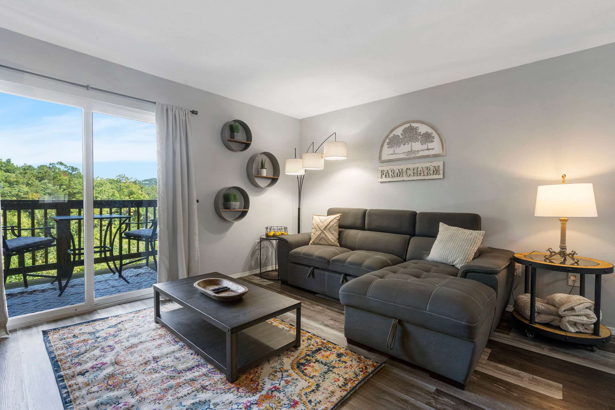 Living room with sofa, TV, and balcony access