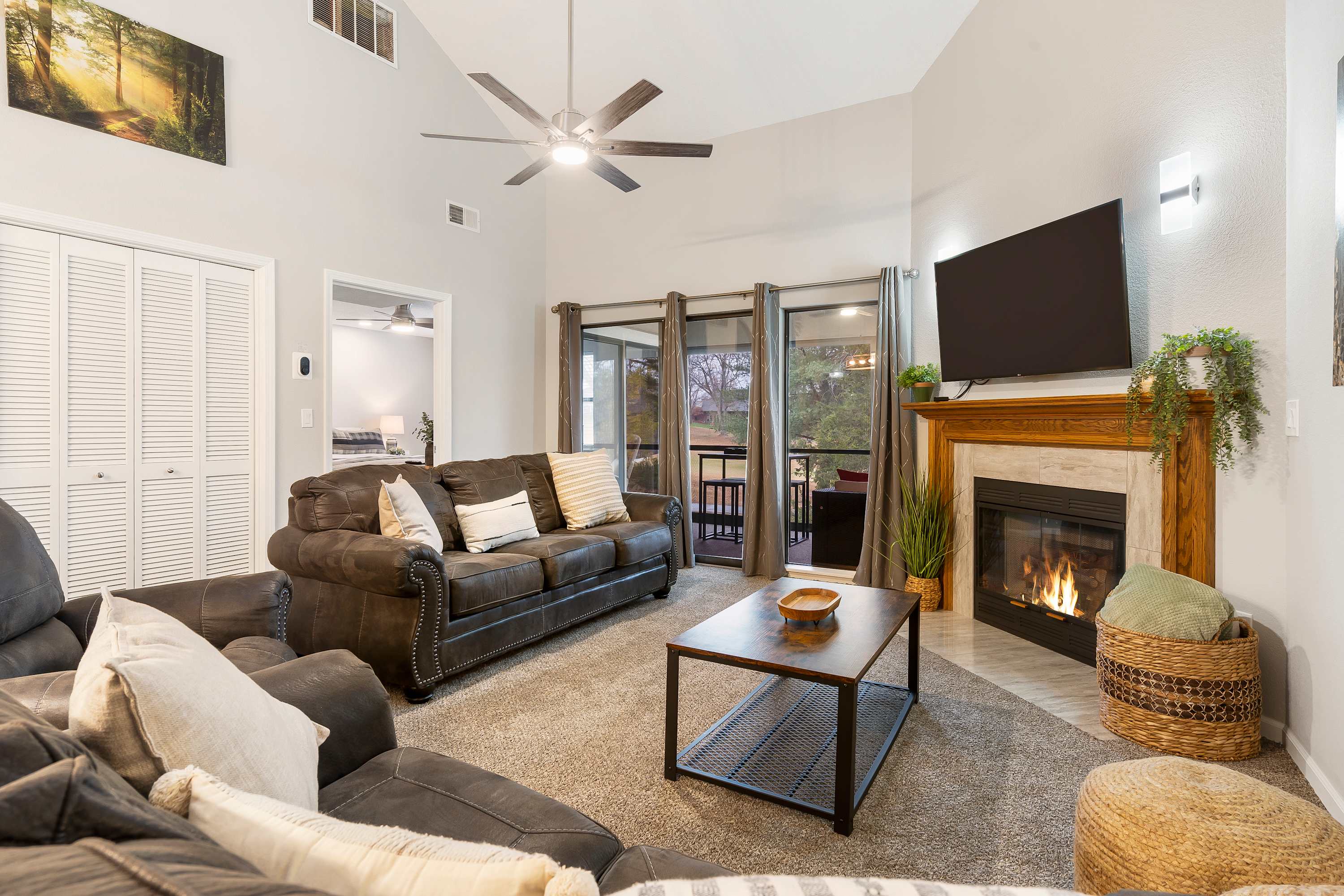 Modern, spacious living area with TV and fireplace