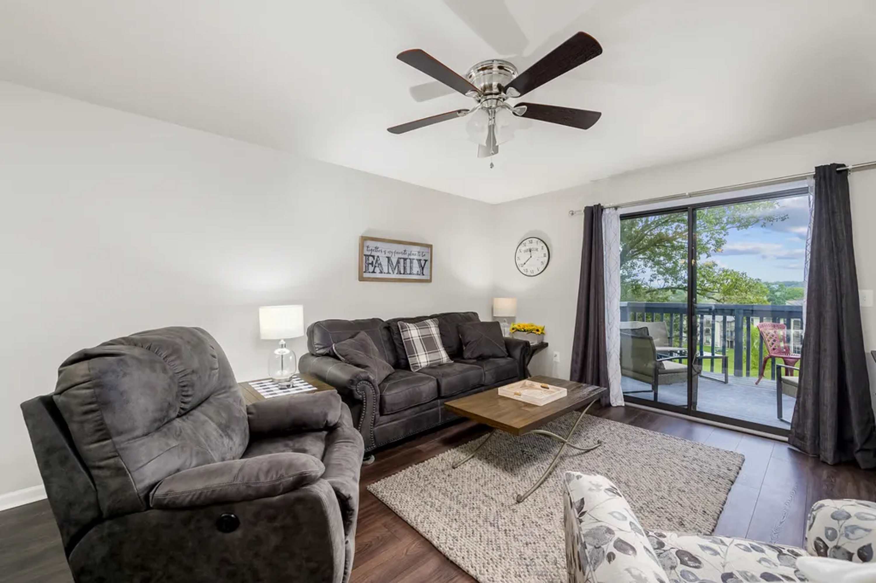 Living room with electric fireplace, and balcony
