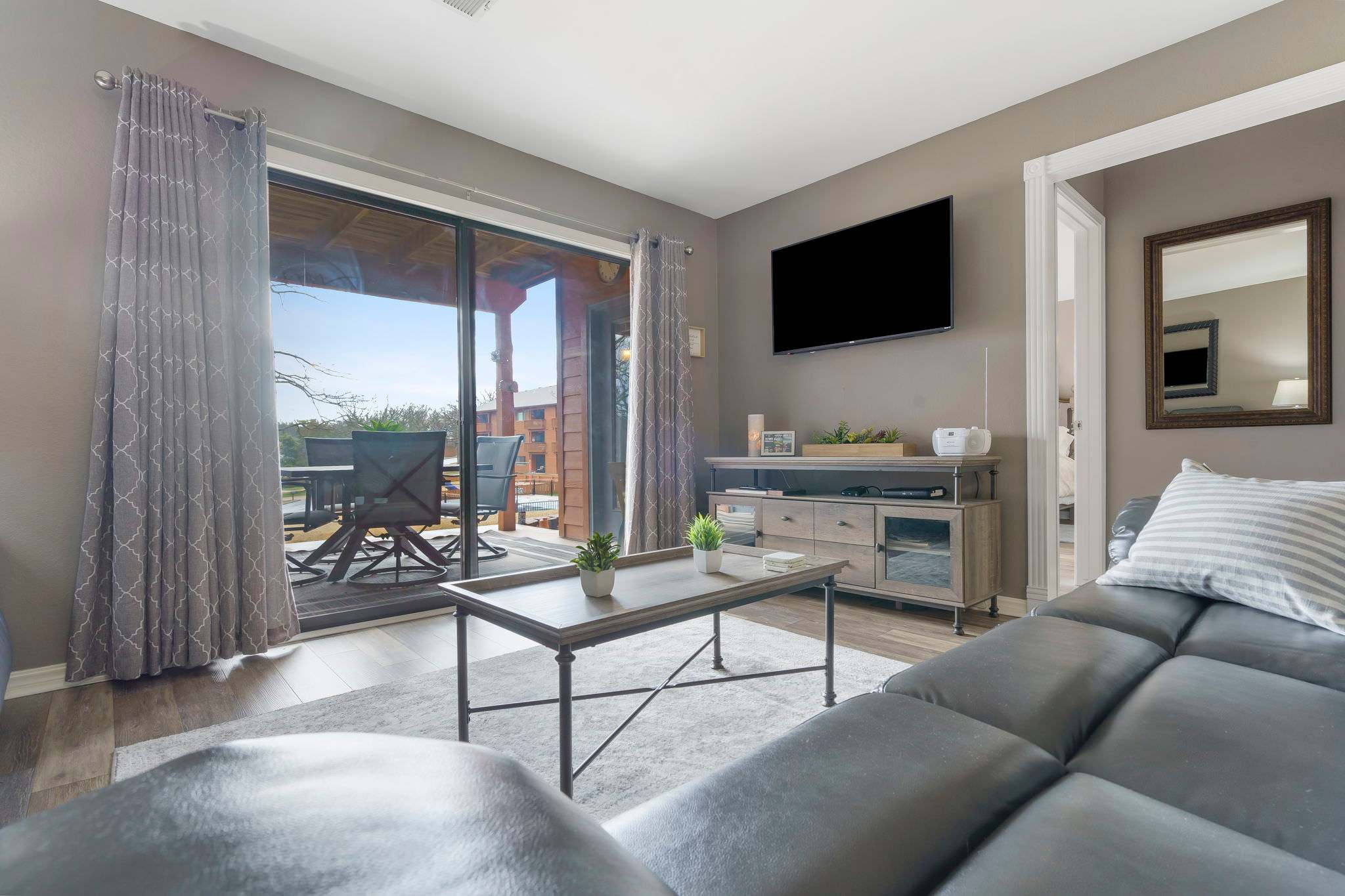 Floor-to-ceiling sliding glass doors in the living area