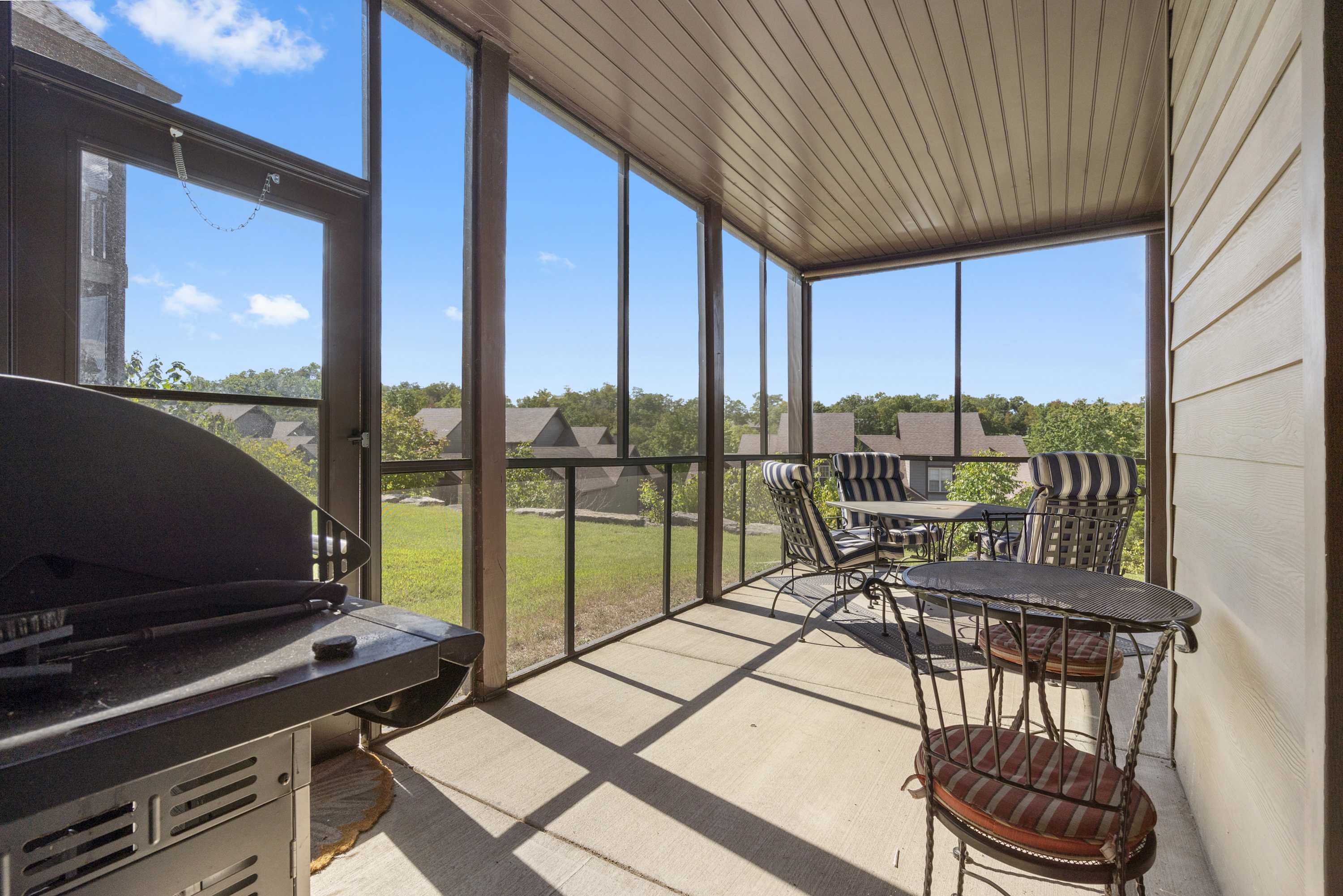 Covered patio with BBQ grill and dining tables for seating up to 6