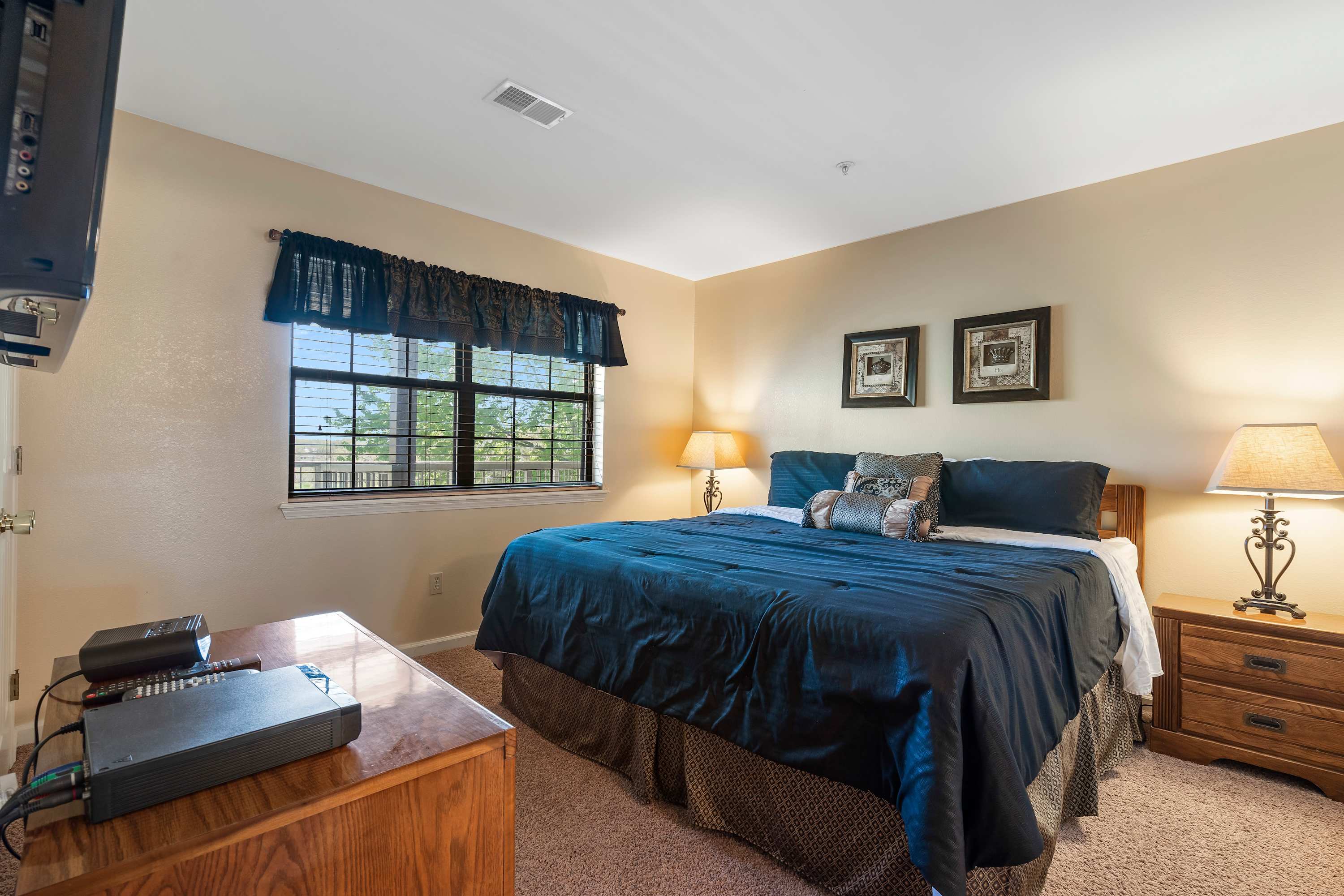 Bedroom 1 with King bed, TV and private en-suite