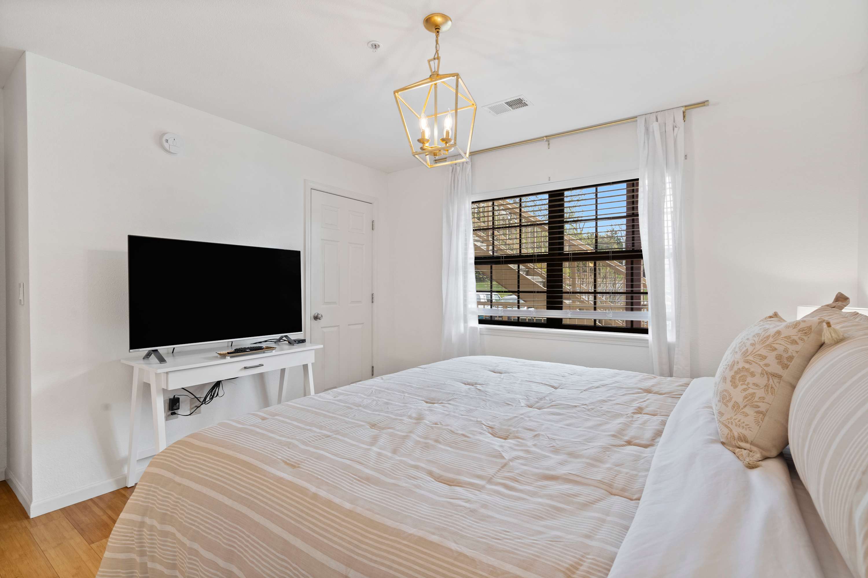 Bedroom 2 with a King bed, Smart TV, and private en-suite