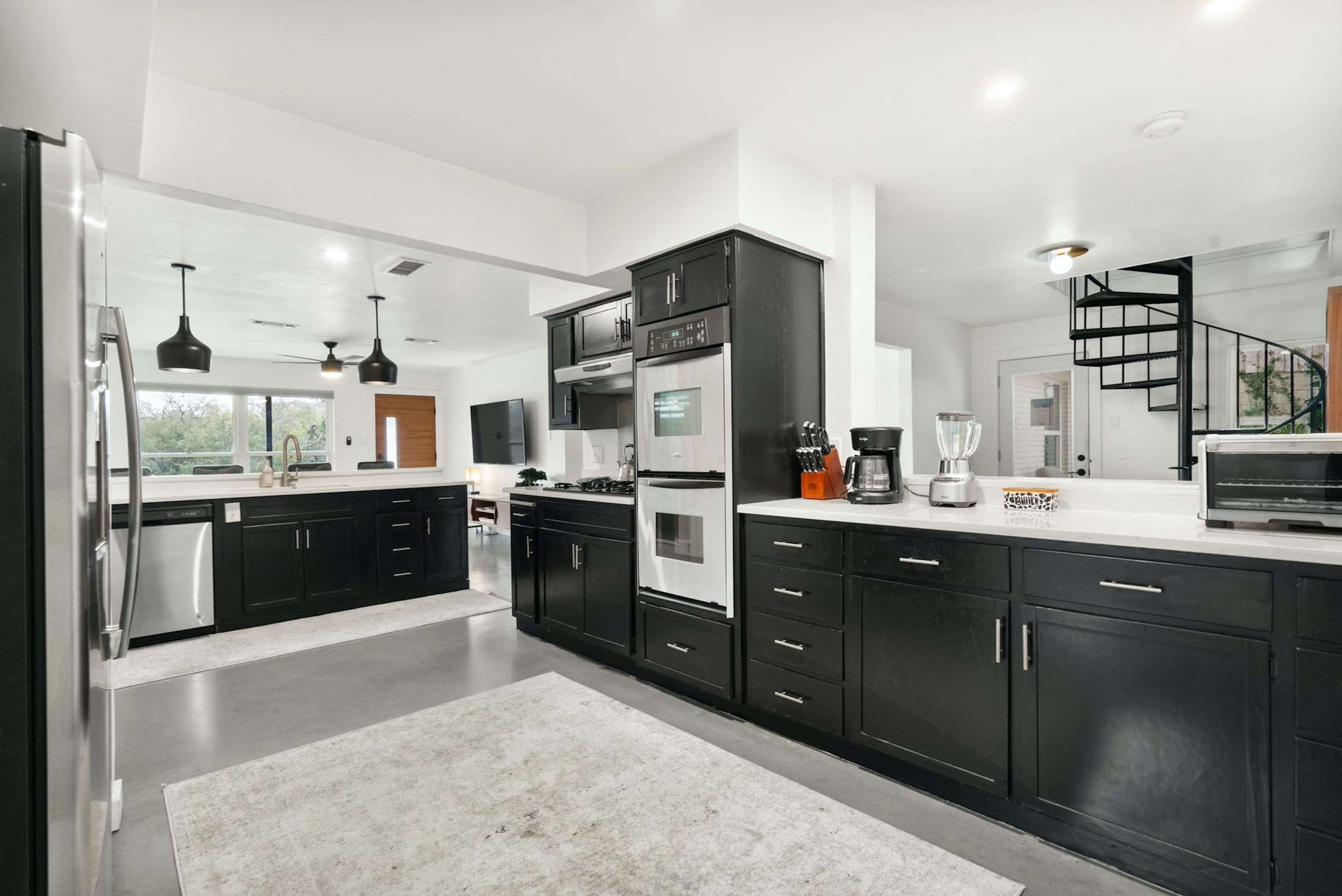 The sleek kitchen offers ample space & all the comforts of home