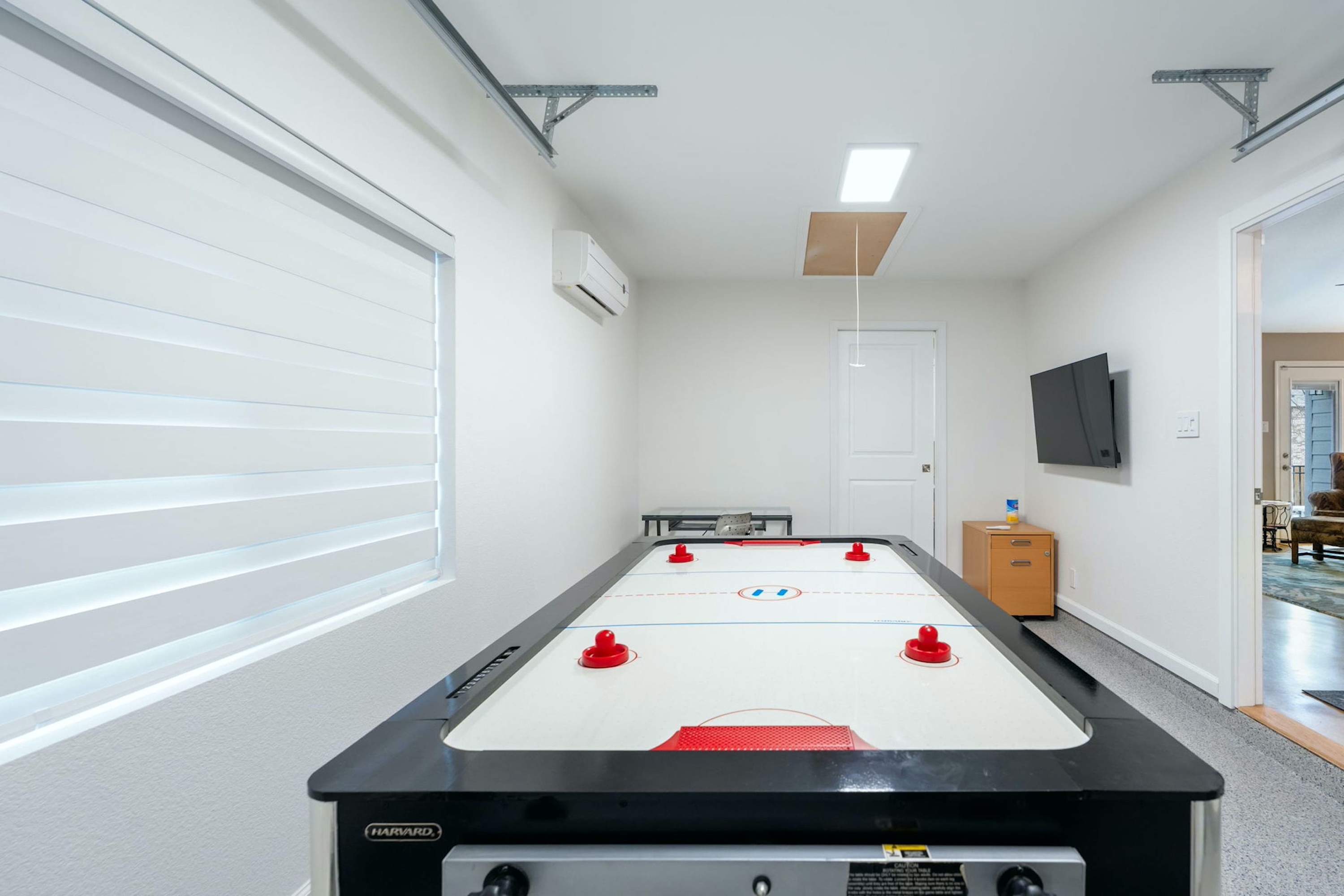 Get competitive with a round of air hockey in the garage game room