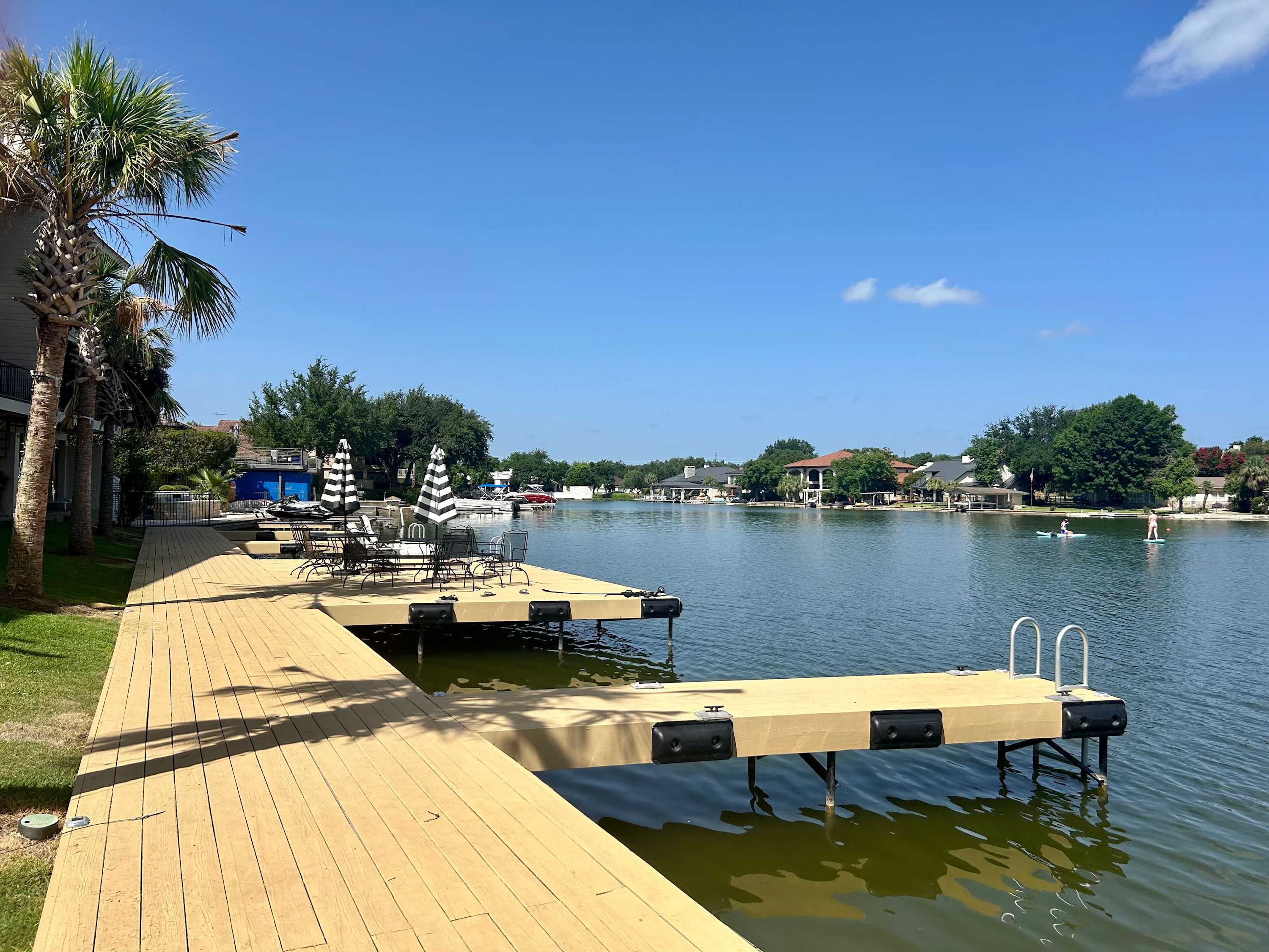 Waterfront deck area with patio tables and chairs