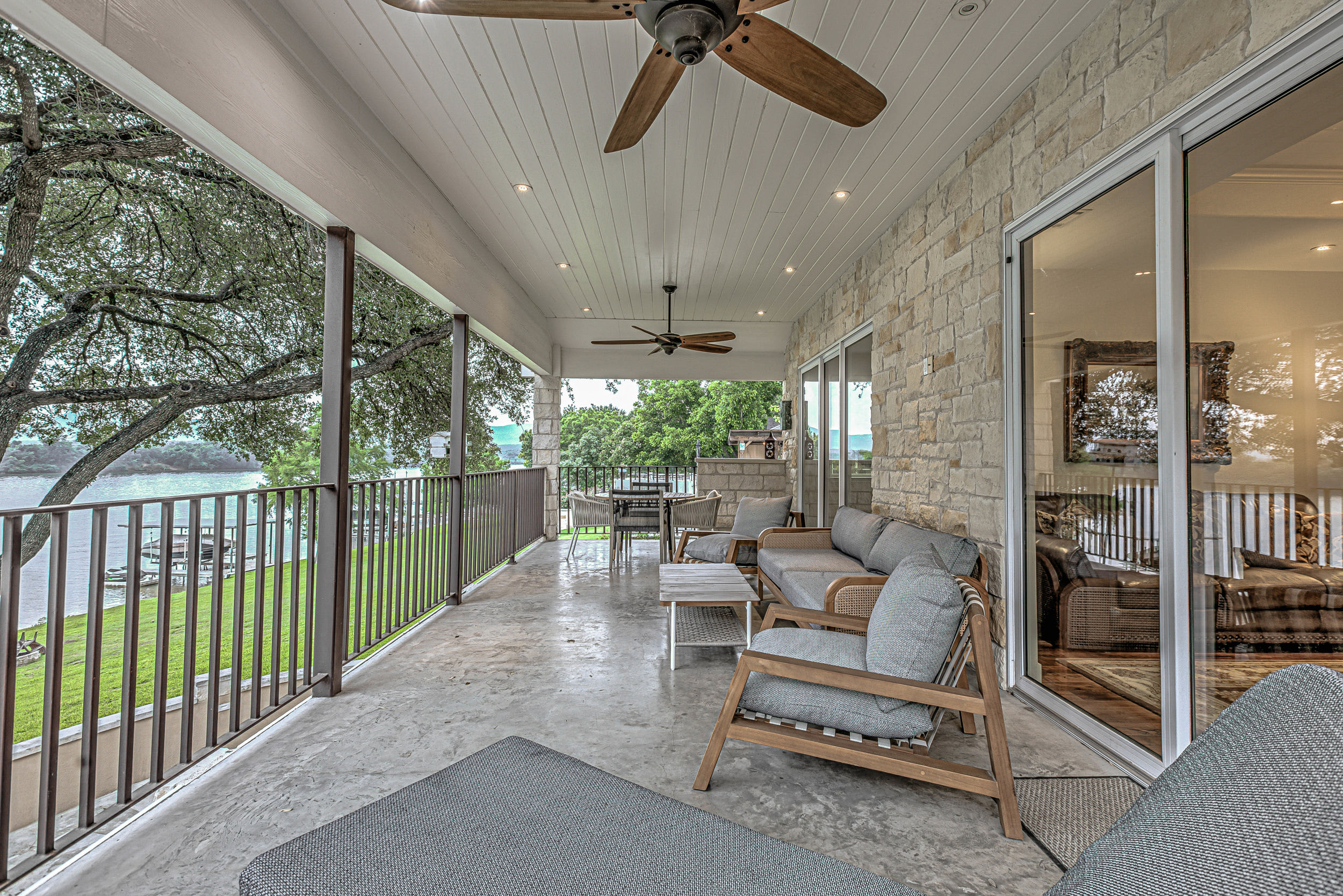 Large deck with outdoor seating and lake view