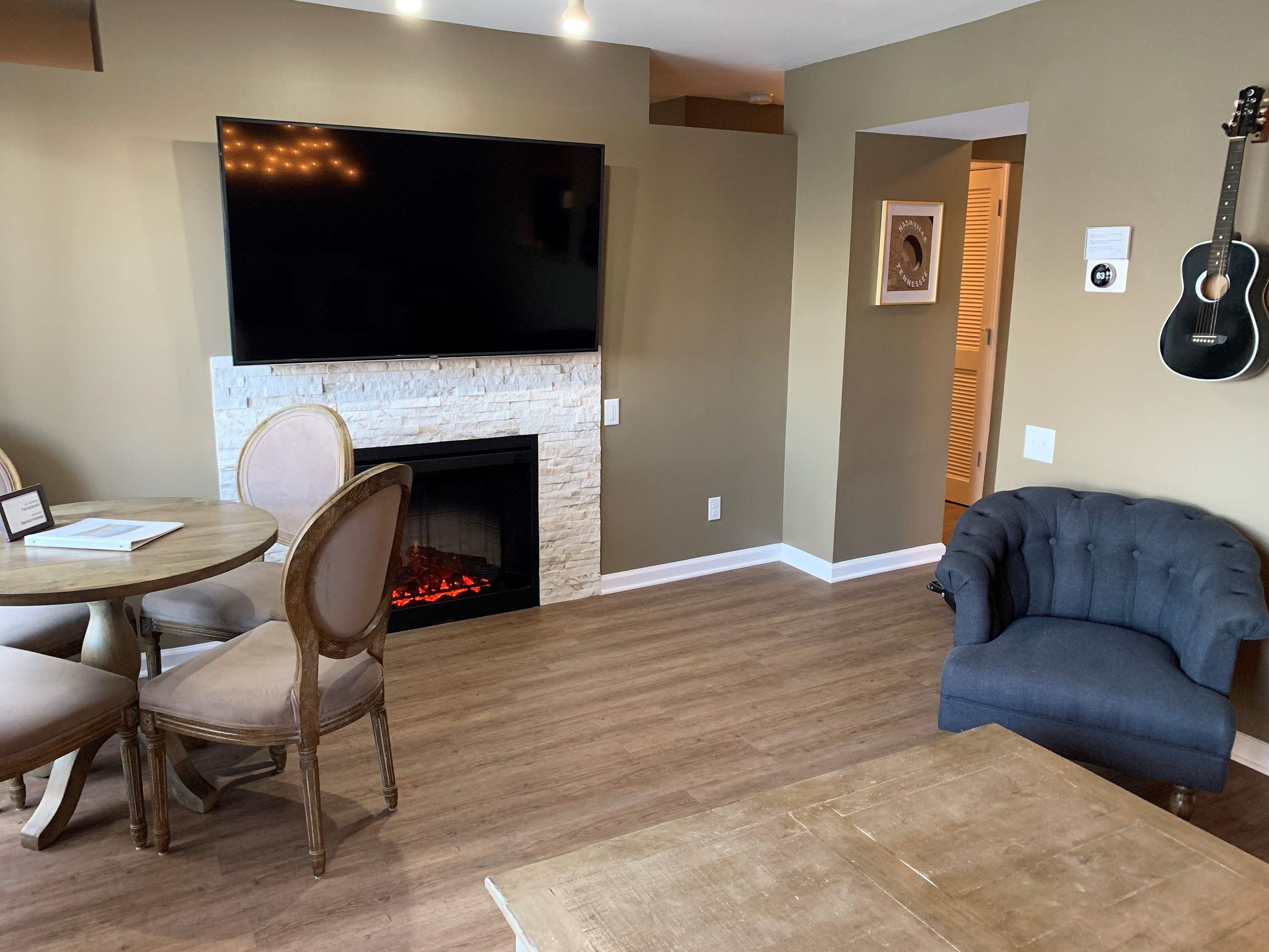 Living room with sofa sleeper, Smart TV, and balcony
