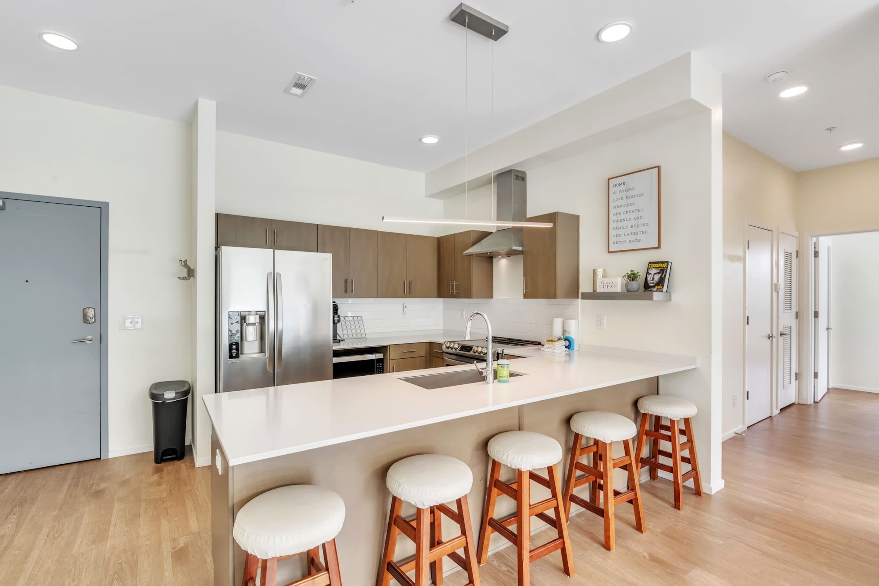 The sleek, open kitchen offers ample space & every home comfort