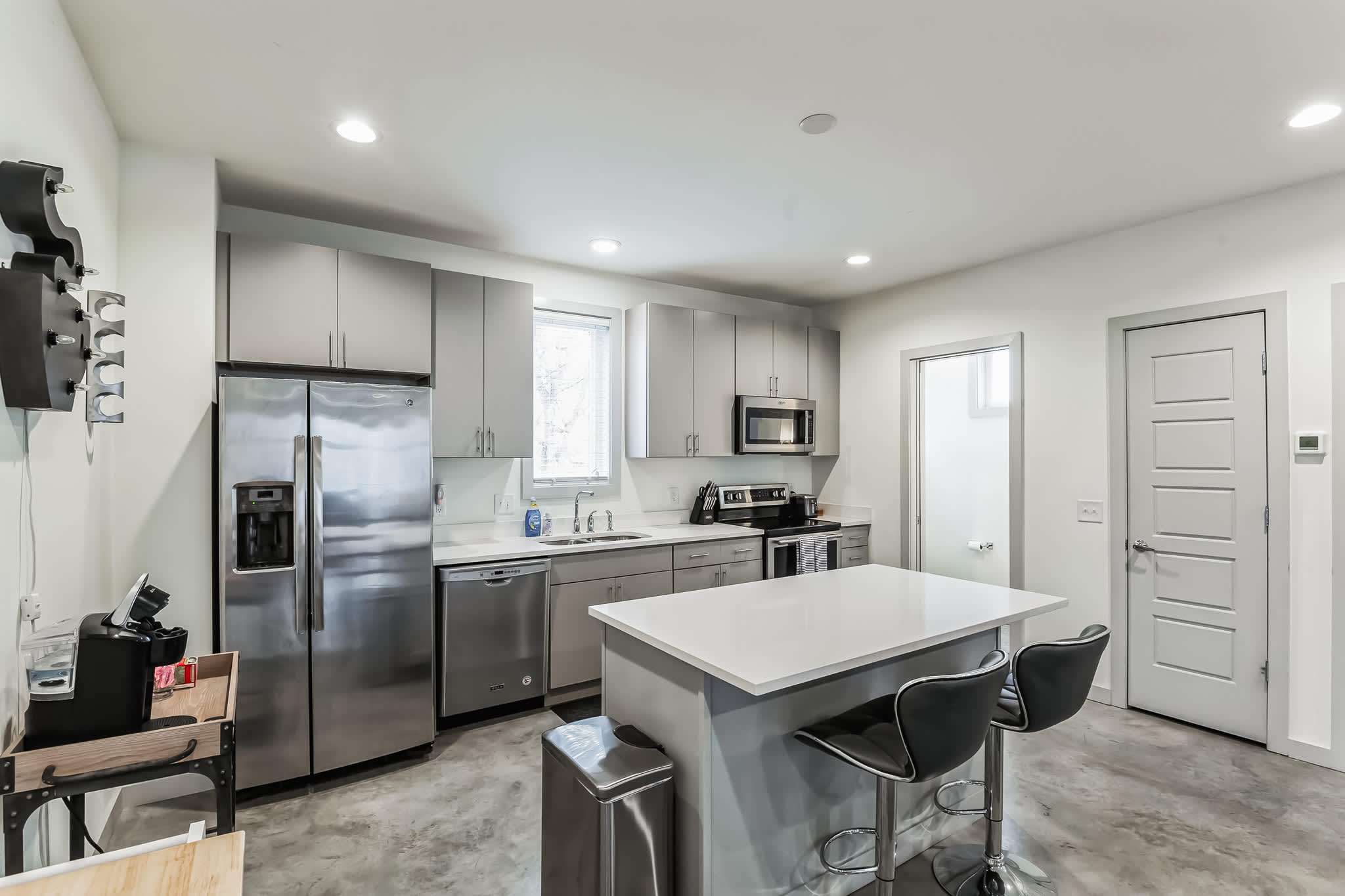 The sleek, open kitchen offers ample space & every home comfort